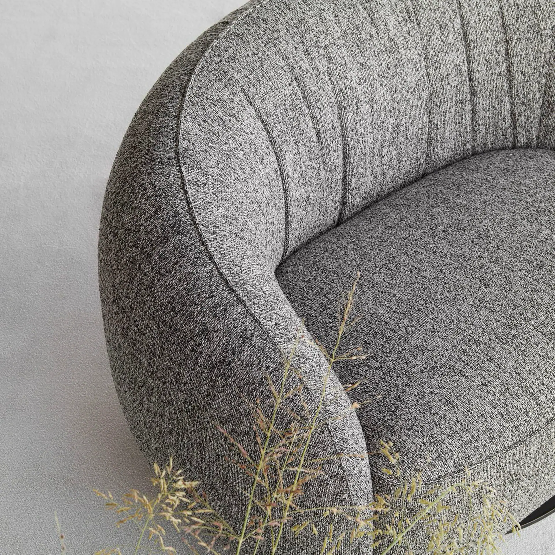 Elegant grey Nest swivel armchair with plush upholstery.