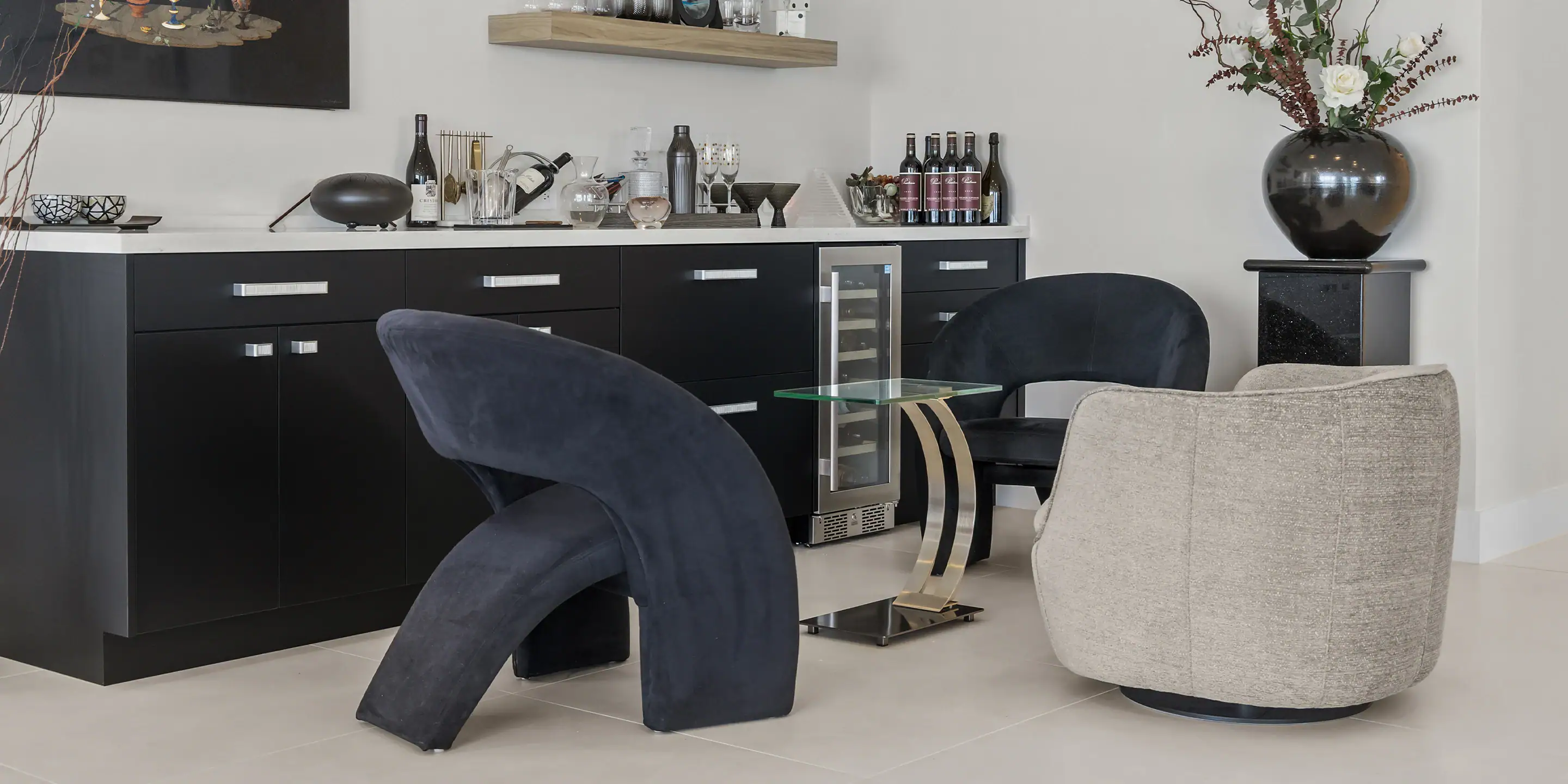 Elegant dining area featuring plush black and beige chairs with a sleek glass table.
