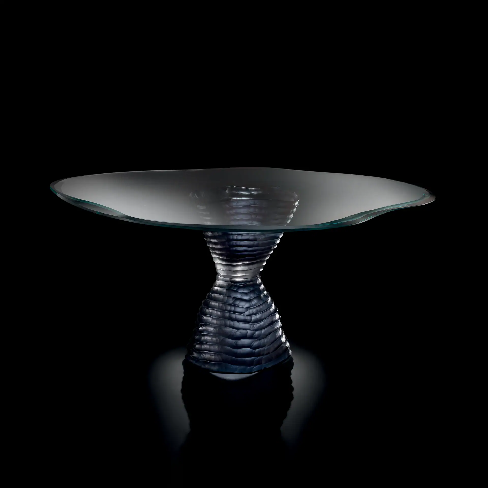Elegant Murano 72 glass dining table with a textured base and clear top.