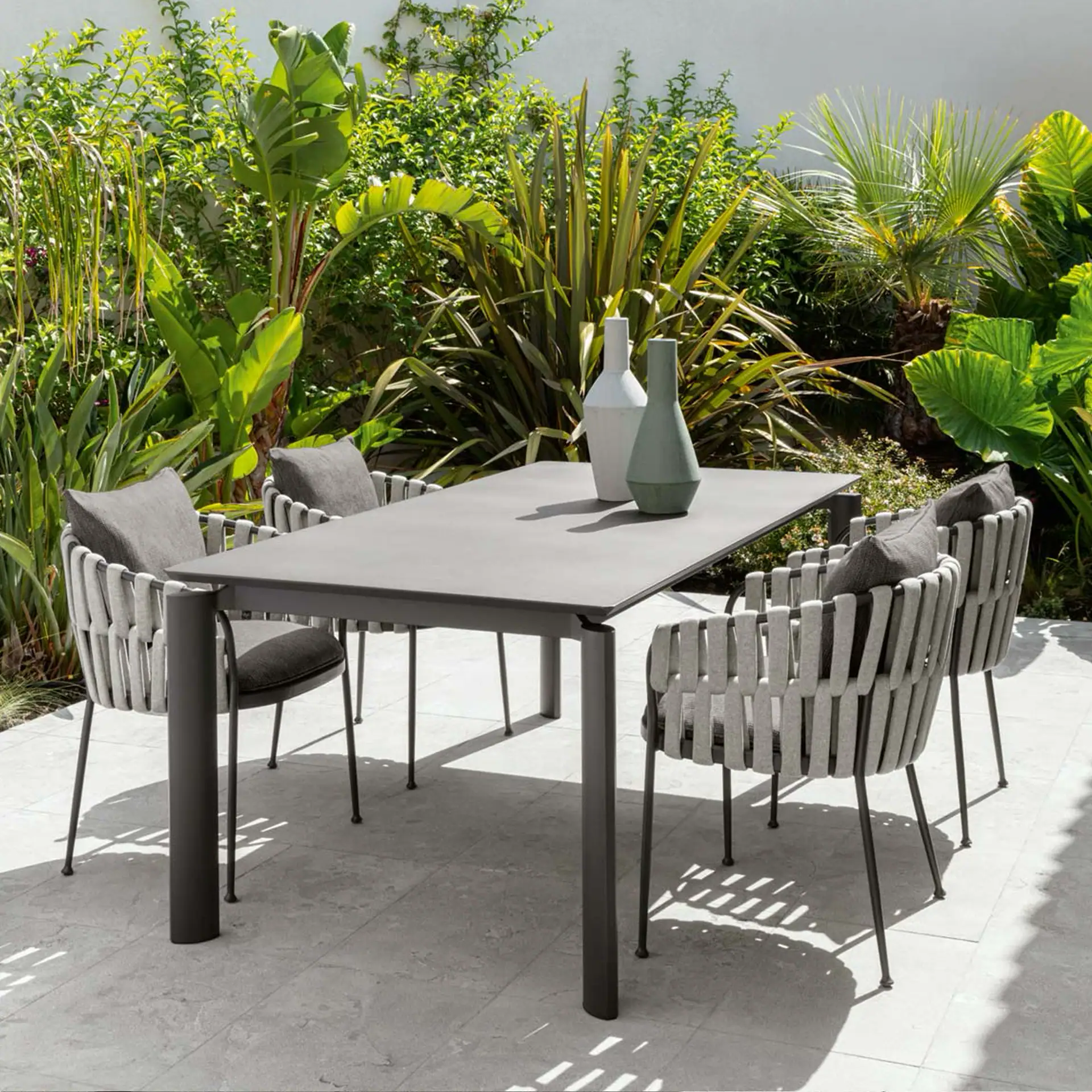 Outdoor dining armchair with striped fabric and metal frame, perfect for patio or garden settings.