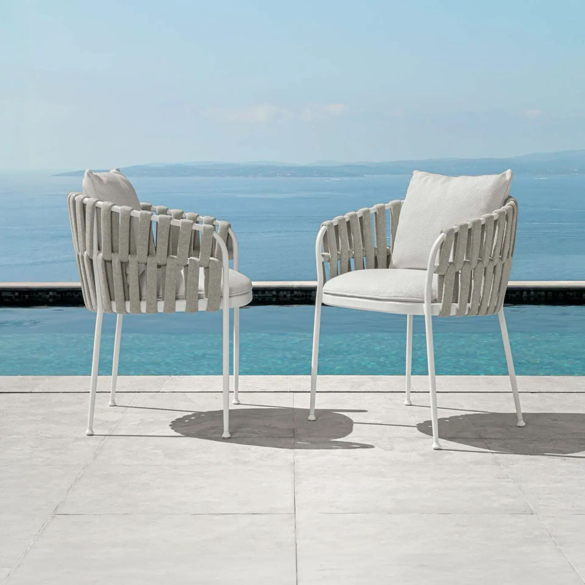 Outdoor dining armchair with woven design and plush cushions. Perfect for stylish outdoor spaces and.