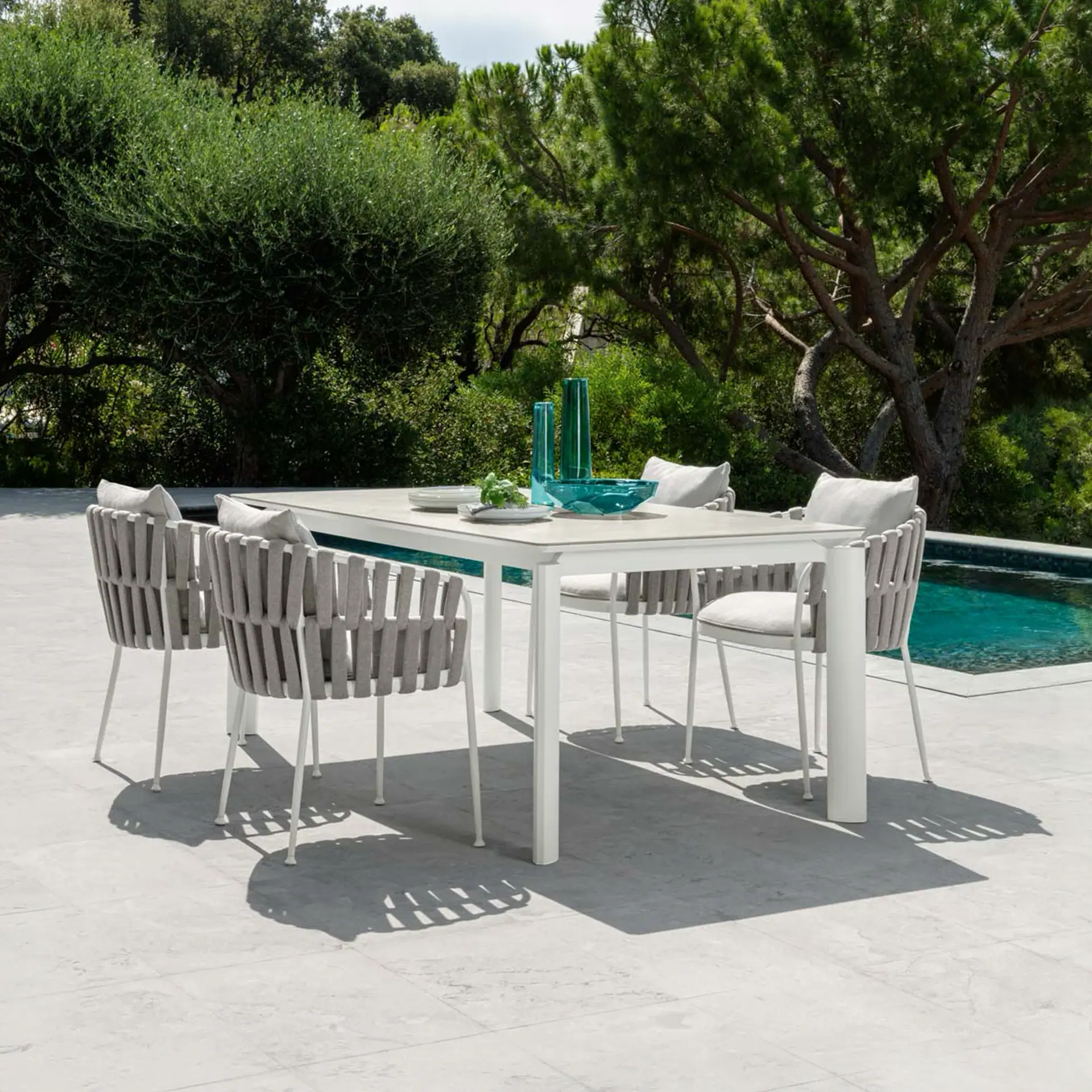 Aluminum outdoor dining armchair with slatted backrest, perfect for patio or garden dining.
