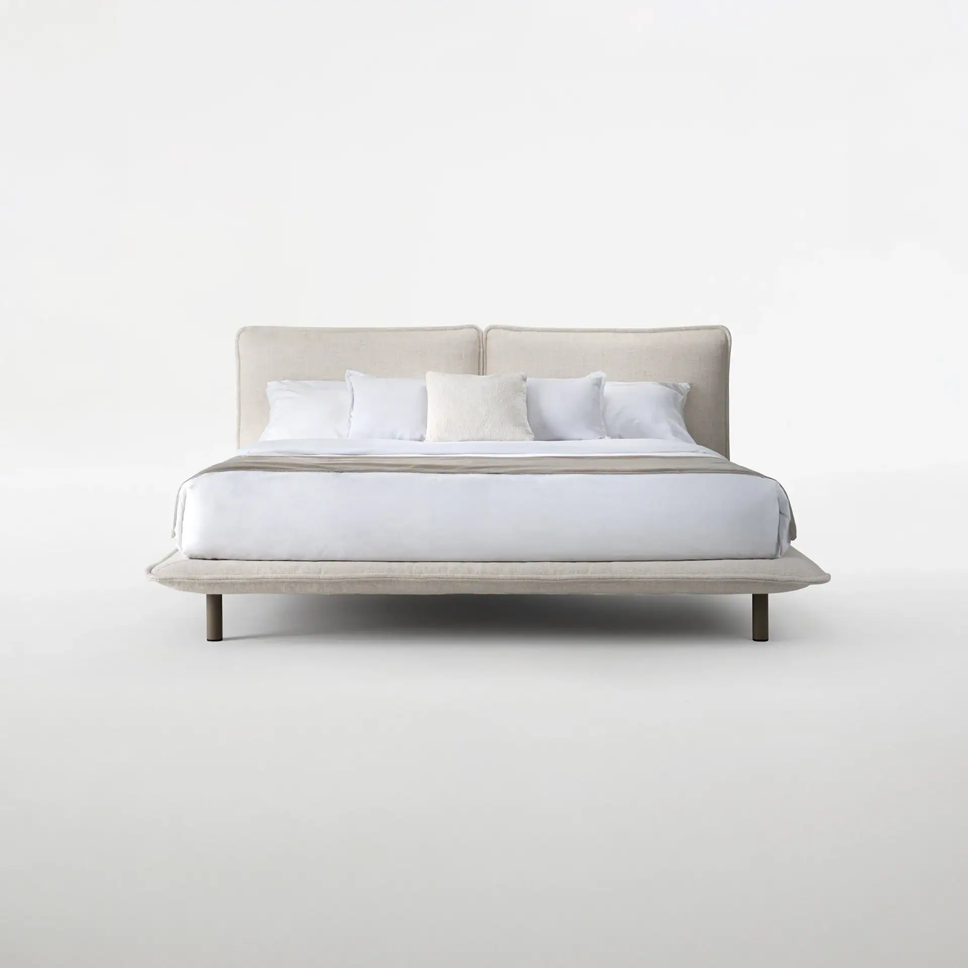 Haven Upholstered Bed with white bedding and pillows in a minimal setting.