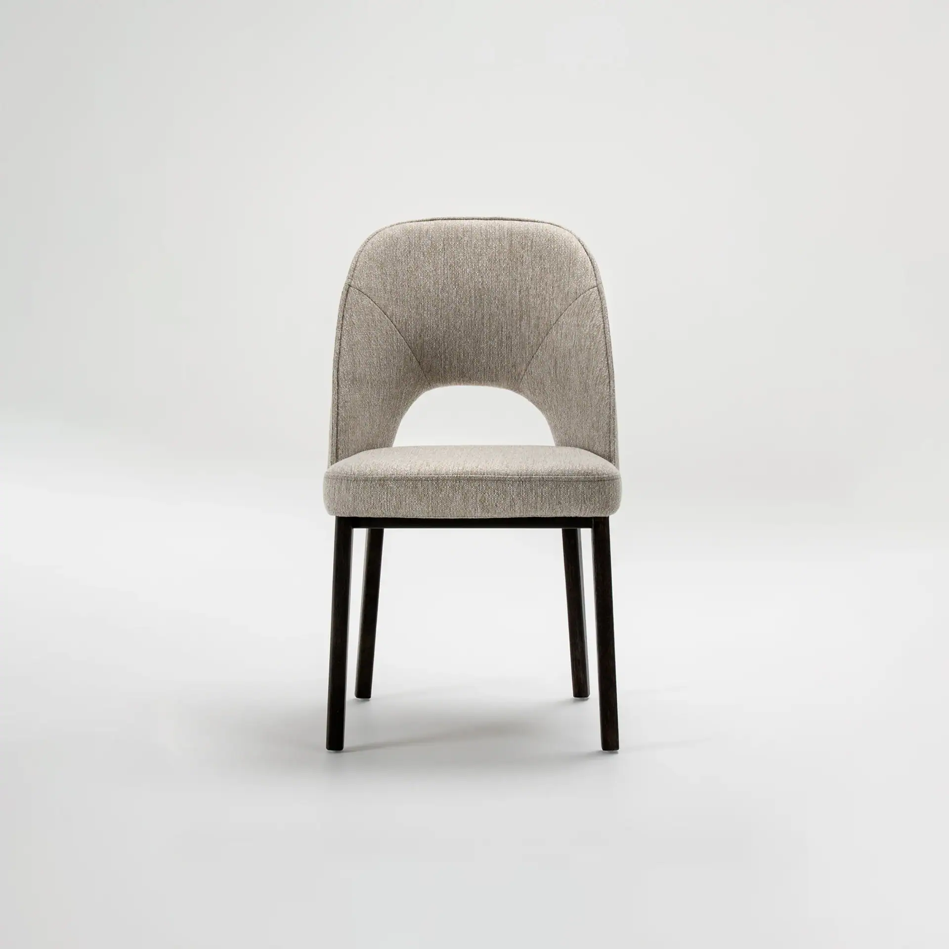 Elegant Mia dining chair with upholstered seat and backrest, black wooden legs.