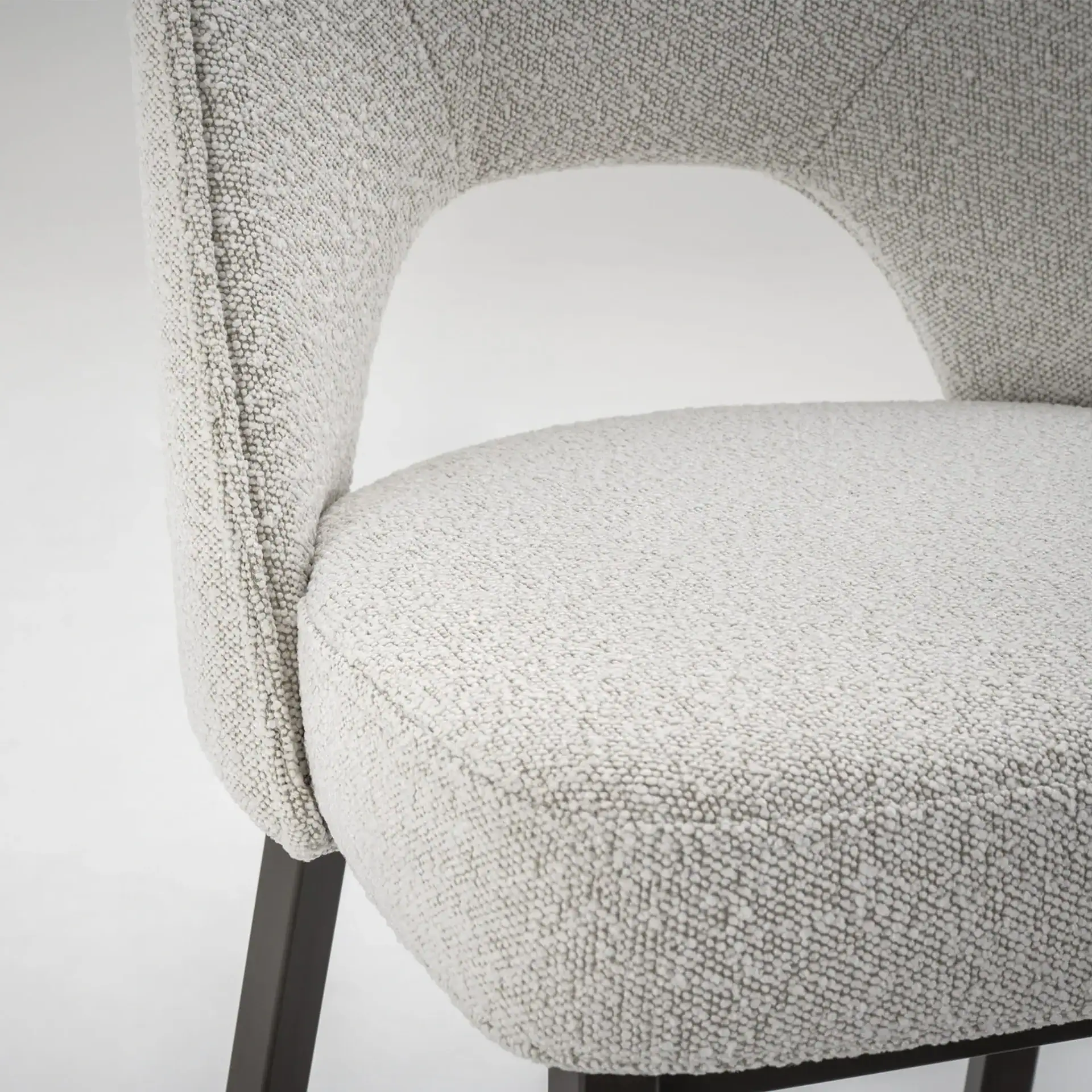 Stylish Mia dining chair with textured fabric and sleek black legs.