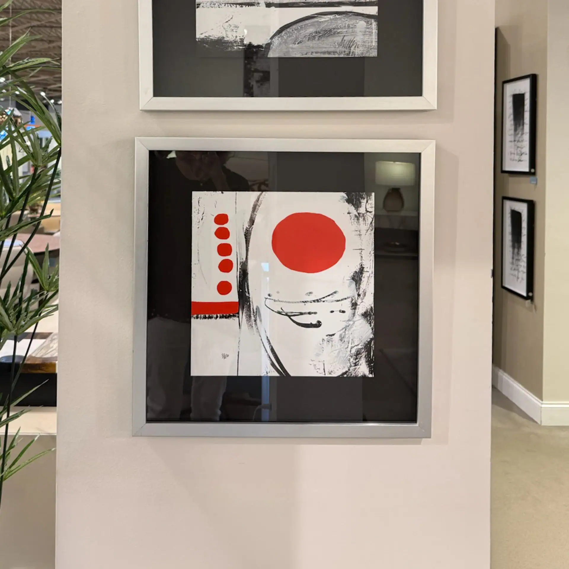 Abstract art piece with bold red, black, and white elements for contemporary interior design.