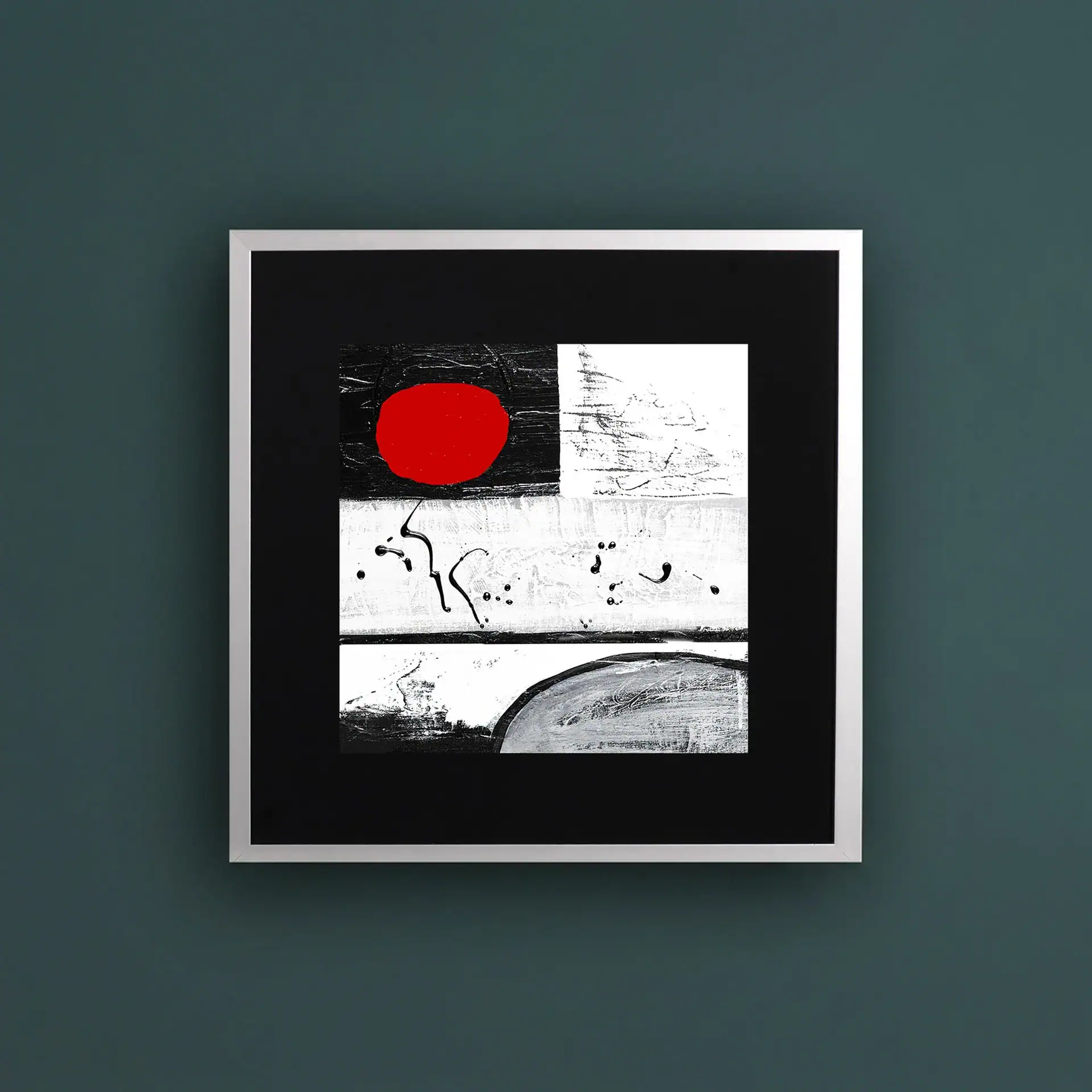 Abstract black and white artwork with a bold red accent, framed and displayed on a dark green wall.