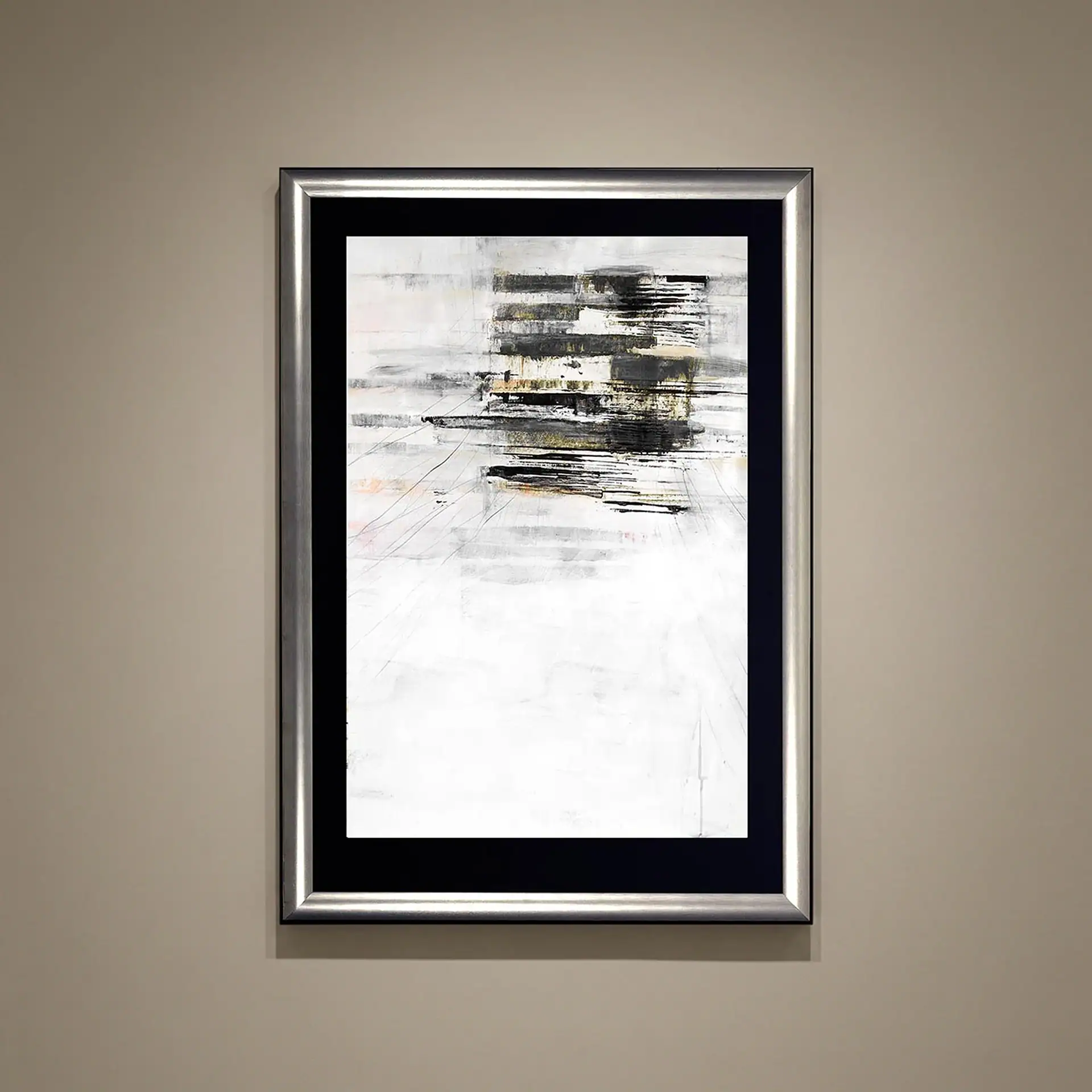 Abstract paper art with black, white, and gold accents in a silver frame.