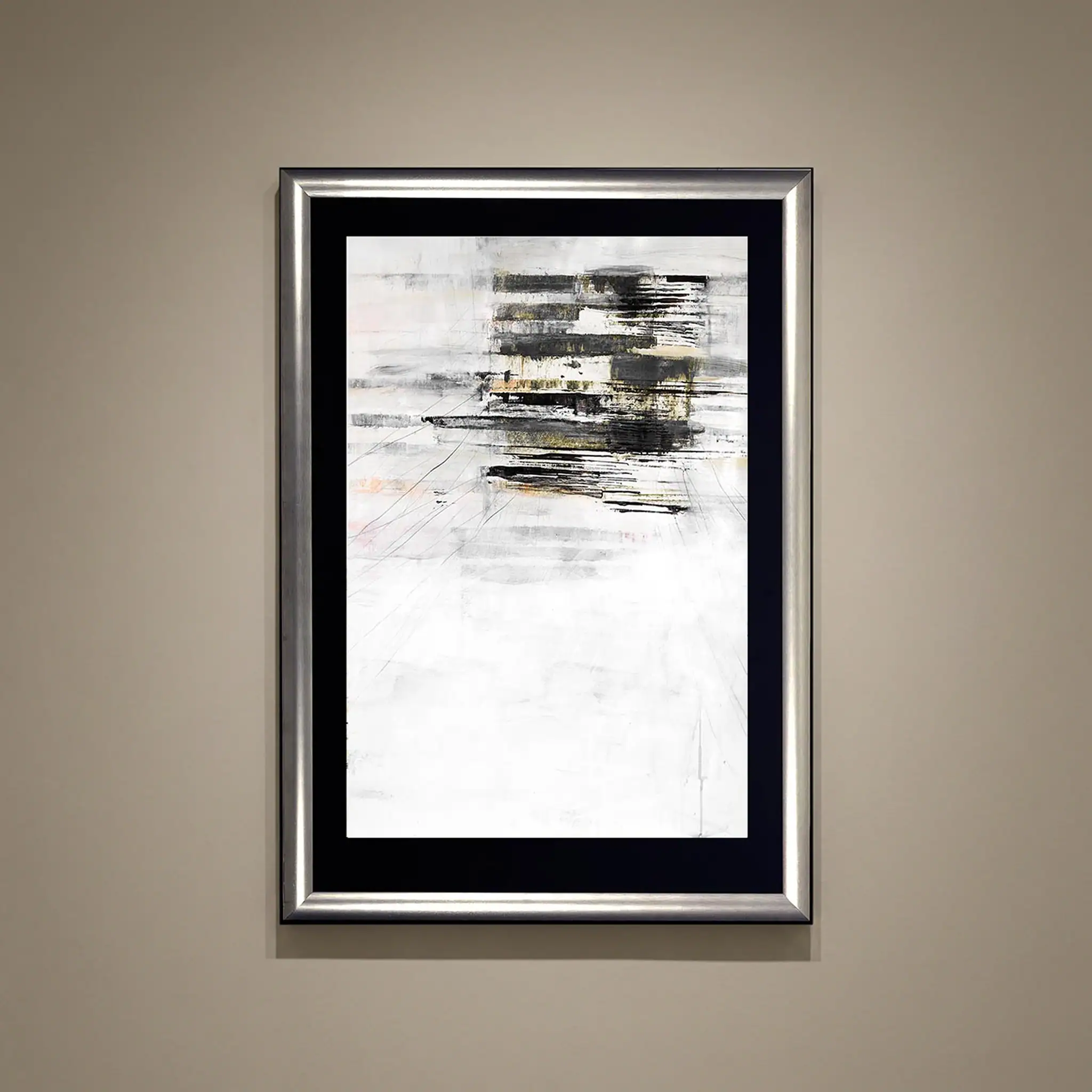 Abstract paper art with black, white, and gold accents in a silver frame.
