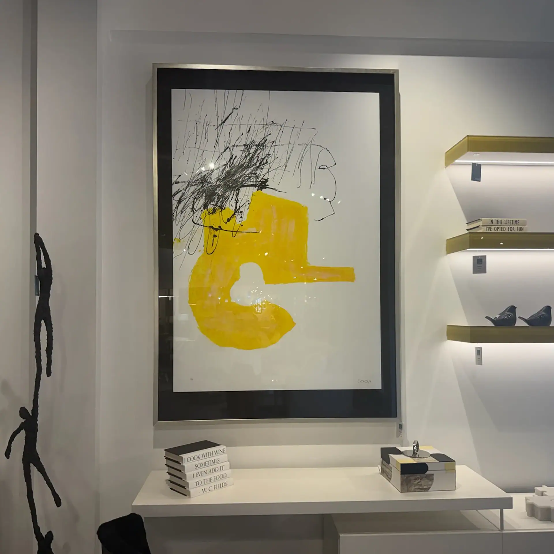 Modern abstract art piece with yellow and black accents at Sklar Furnishings.