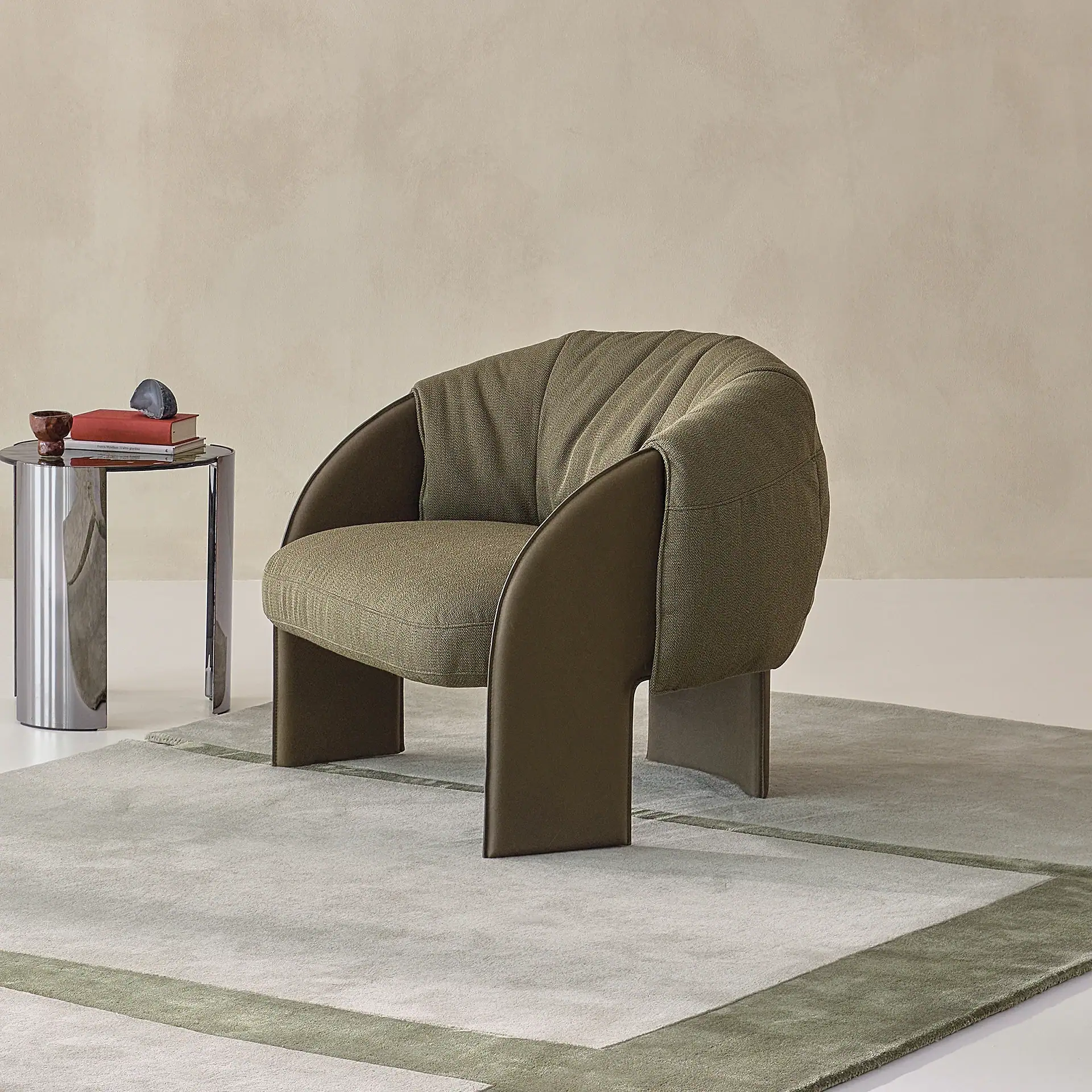 Modern armchair with olive green upholstery and curved design.