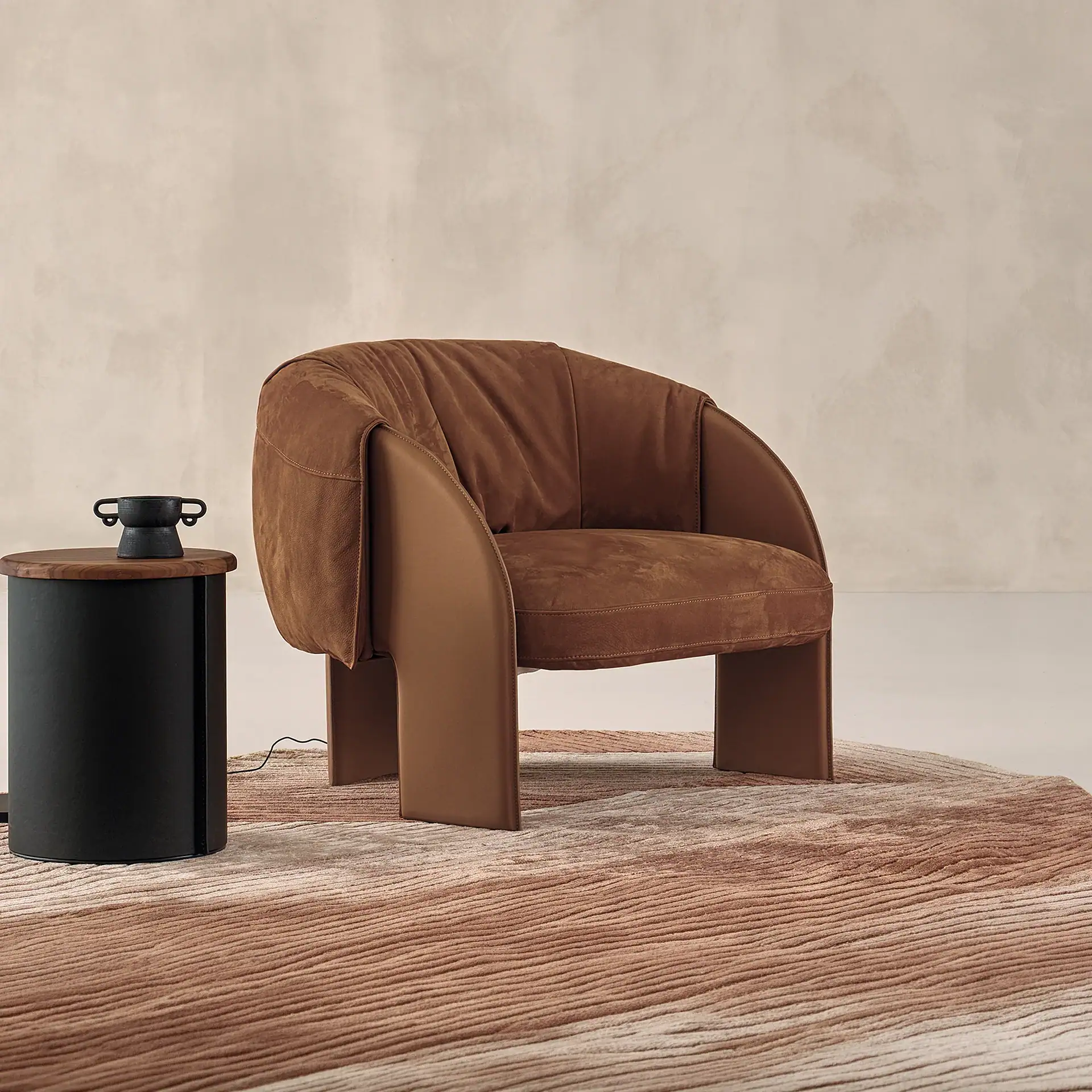 Modern Bella armchair with brown upholstery and unique curved design.