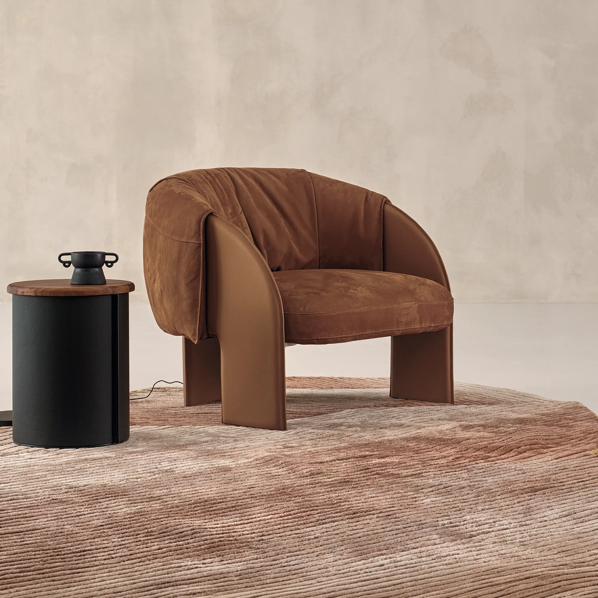 Sklar Furnishings Bella Armchair in brown suede with curved arms in a neutral room.