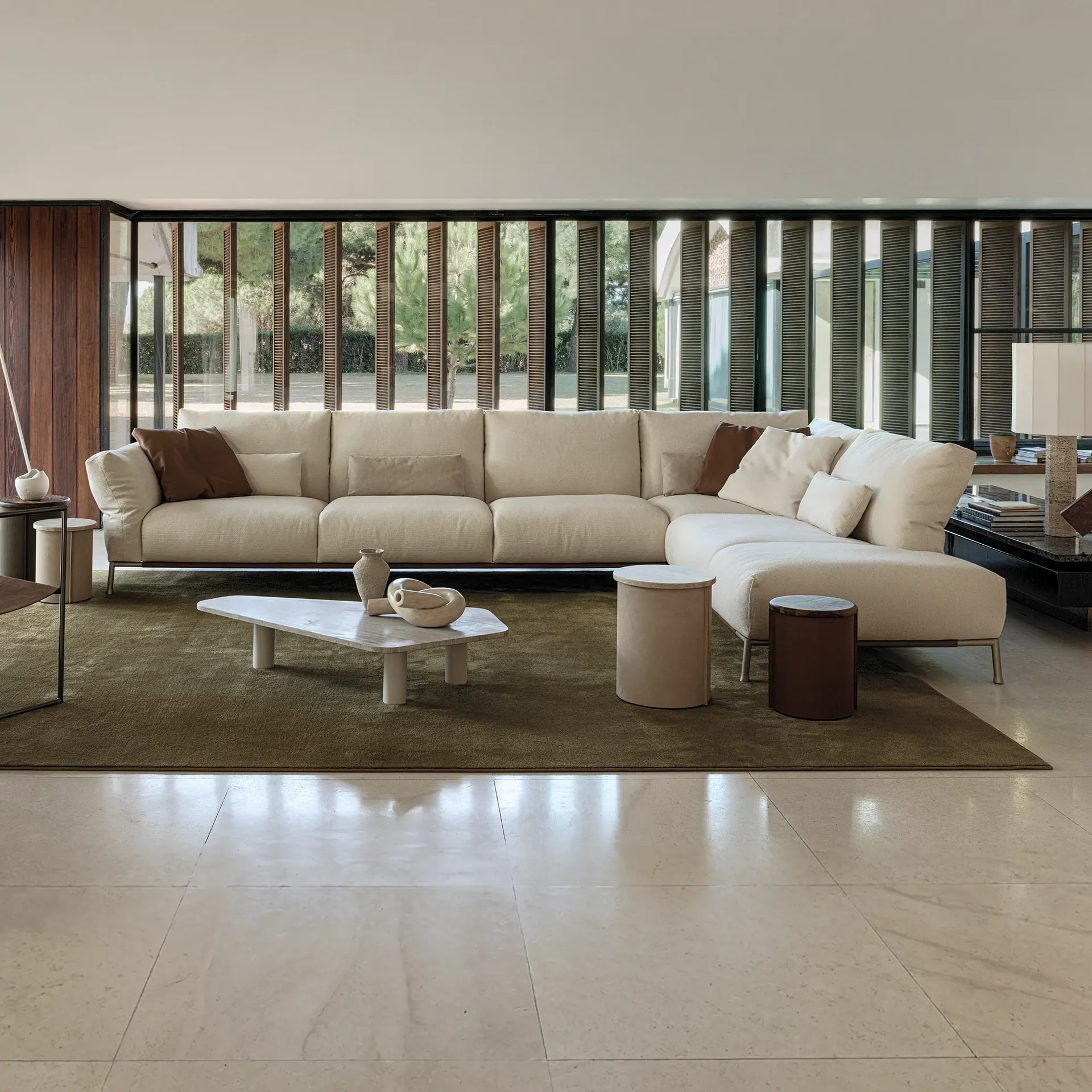 Chapeau Modular Sofa in a bright contemporary living room with a large sectional and neutral tones.