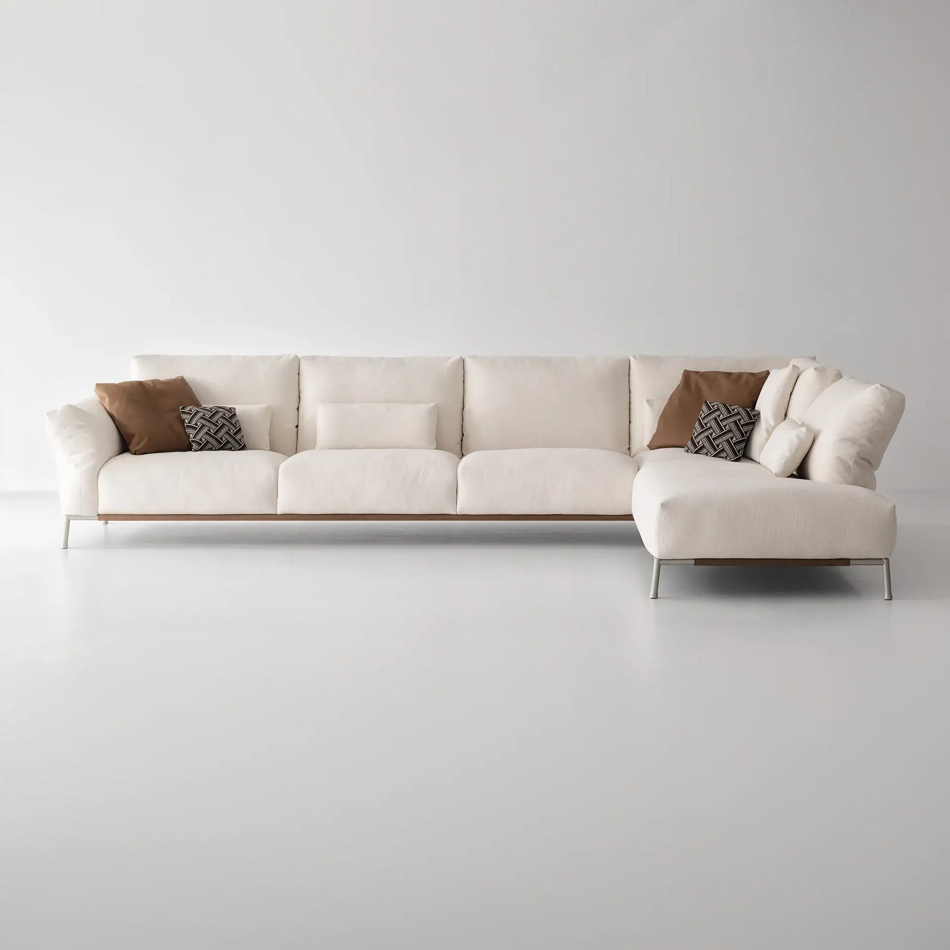 Sklar Furnishings Chapeau modular sectional with cream upholstery and brown accent pillows in a airy.