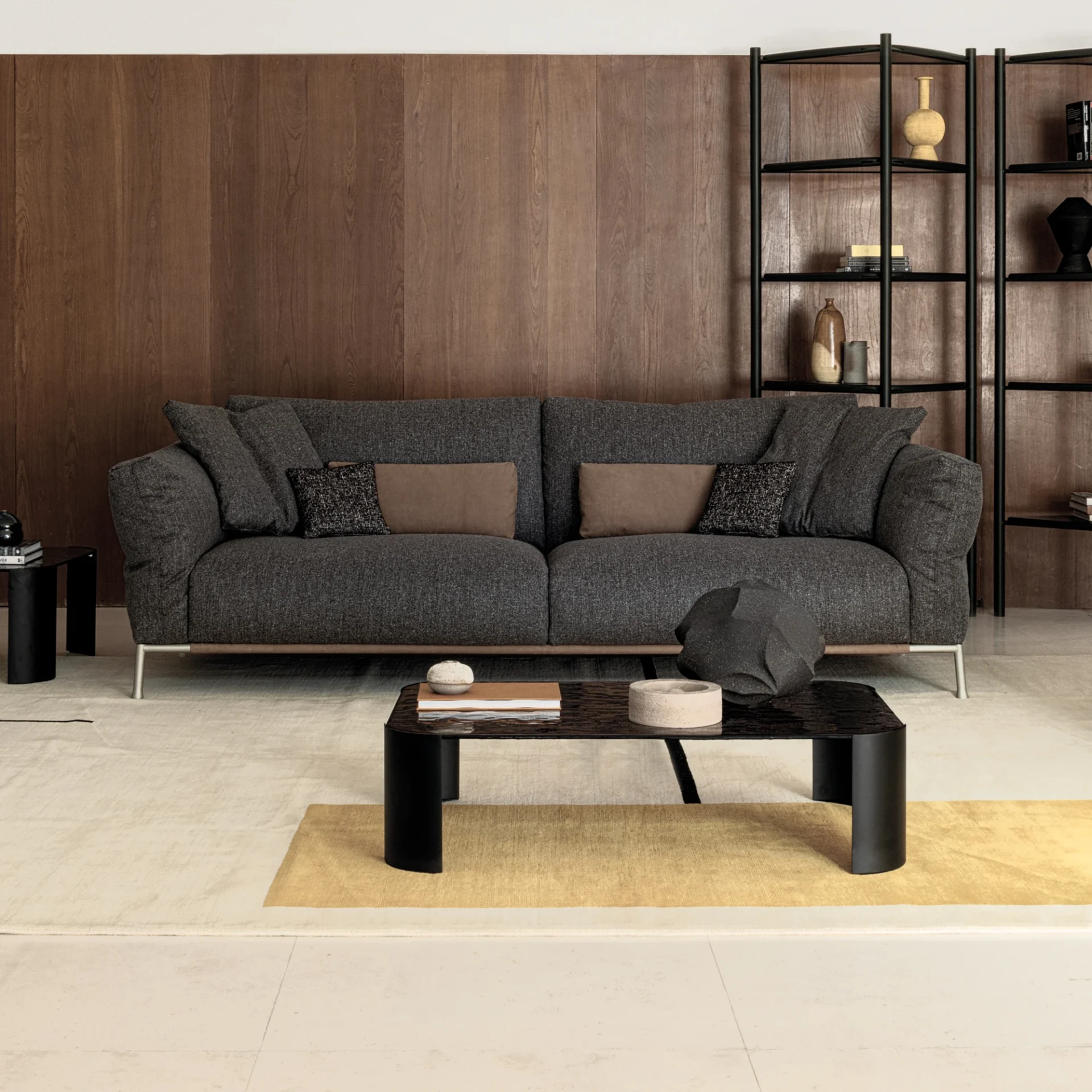 Sklar Furnishings Chapeau sofa in dark gray fabric with brown pillows in a modern living room.
