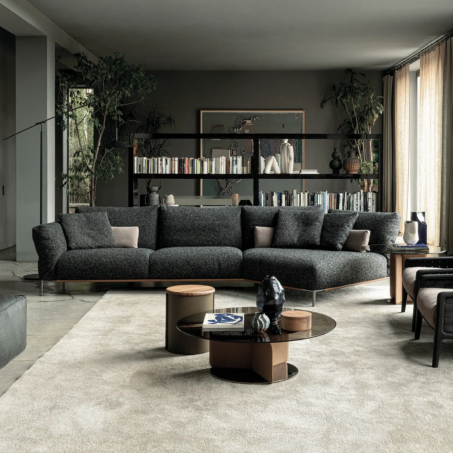 Modern living room with dark gray Chapeau modular sofa and minimalist decor.