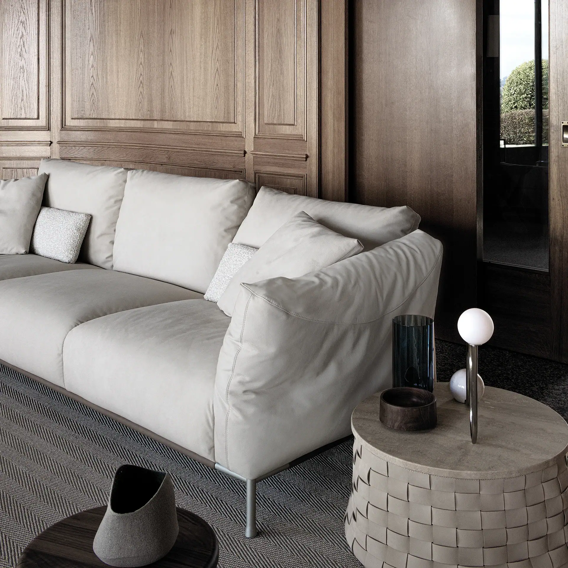 Modern Chapeau Modular Sofa in neutral tones with wooden wall background.