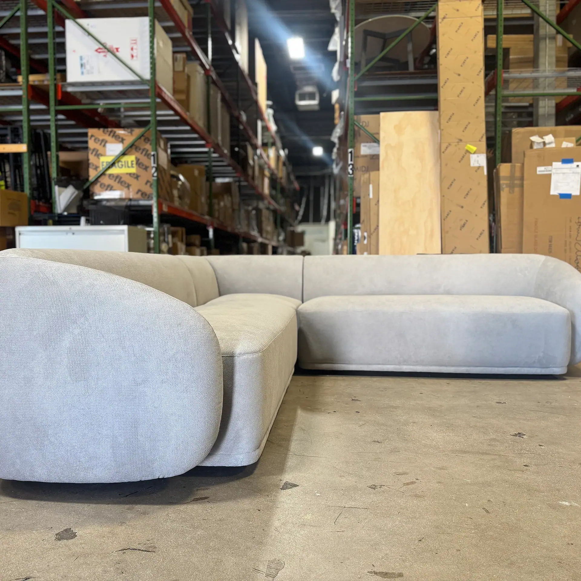 Modern beige sectional sofa in warehouse setting for American Leather Althea 3-Piece Sectional.