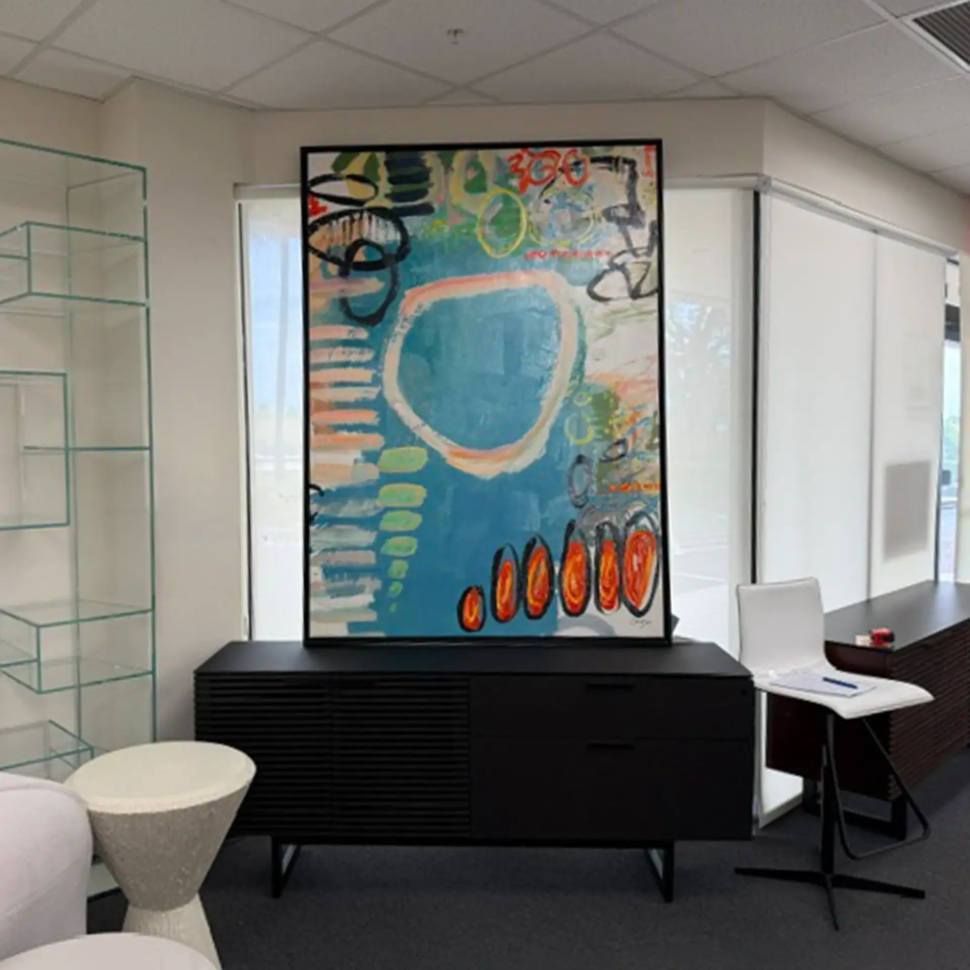 Colorful abstract painting on wall in Sklar Furnishings showroom.