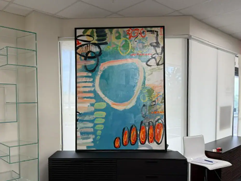 Colorful abstract painting on display in a contemporary gallery setting.