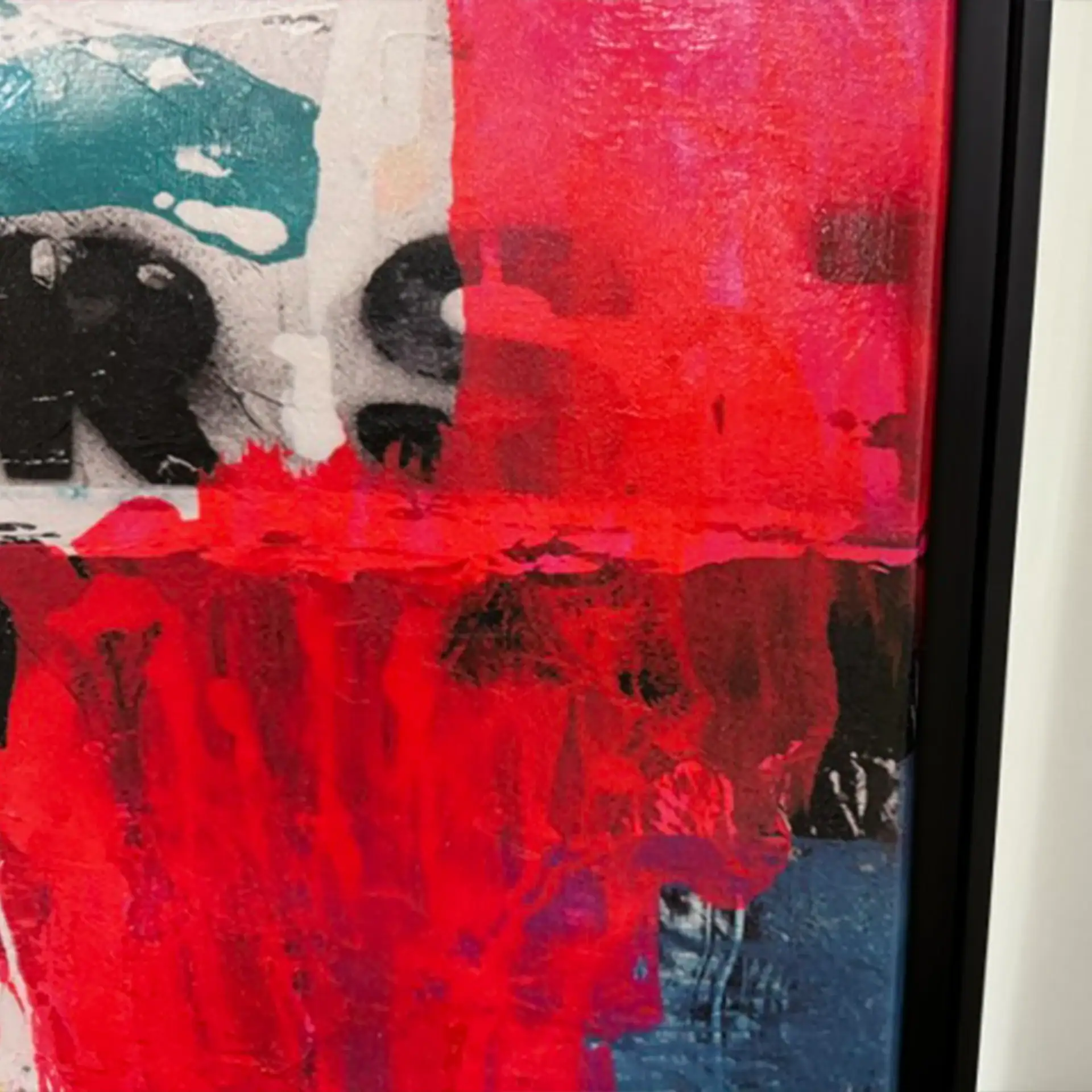 Abstract dog face wall art with vibrant red, black, and white colors.