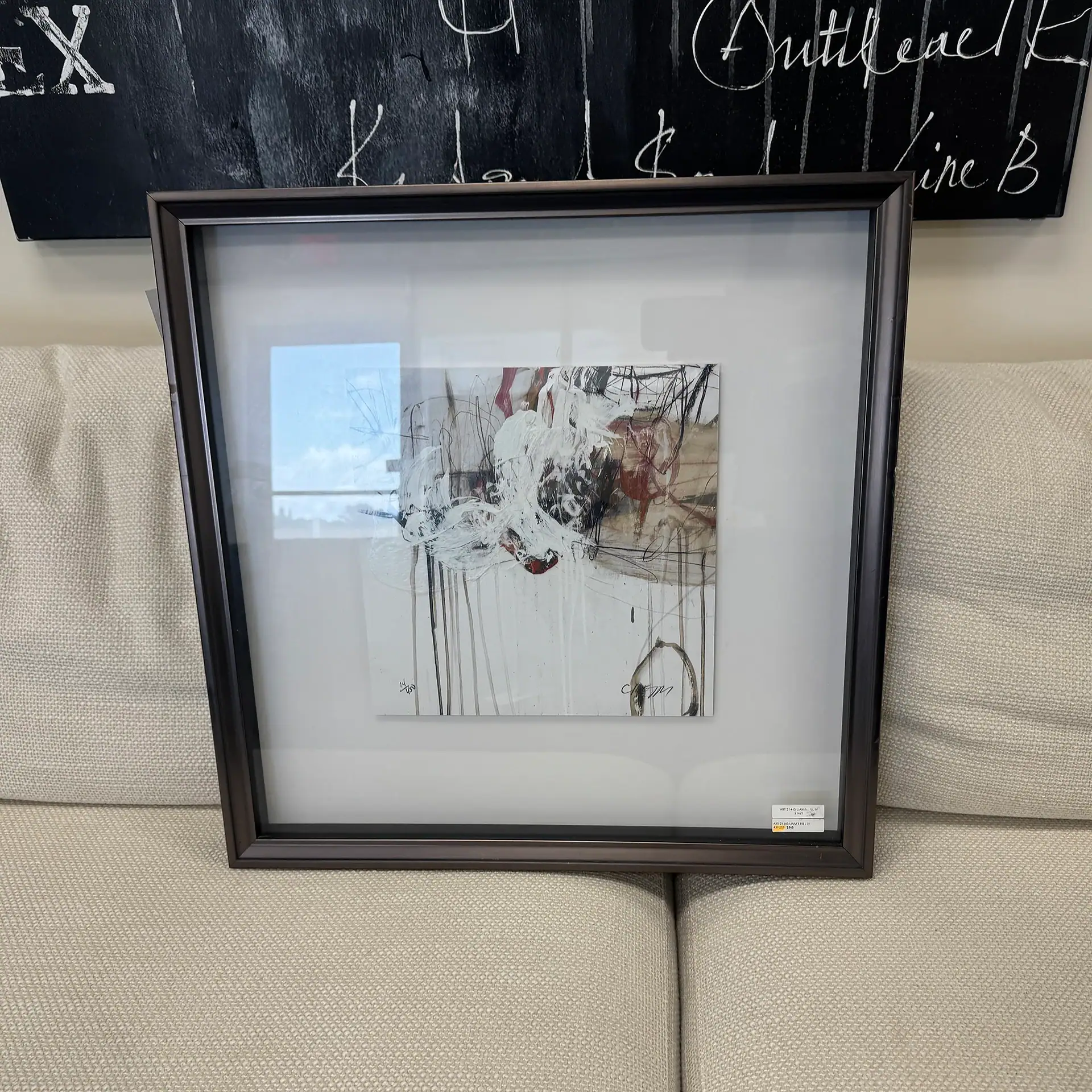 Abstract art in a sleek black frame, perfect for modern home or office decor.