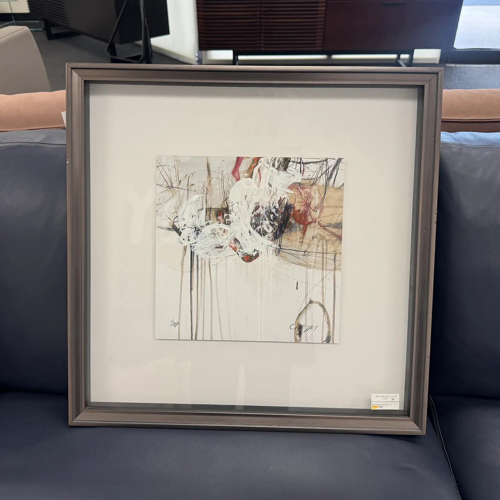 Abstract art piece in a sleek frame, perfect for contemporary interior design.