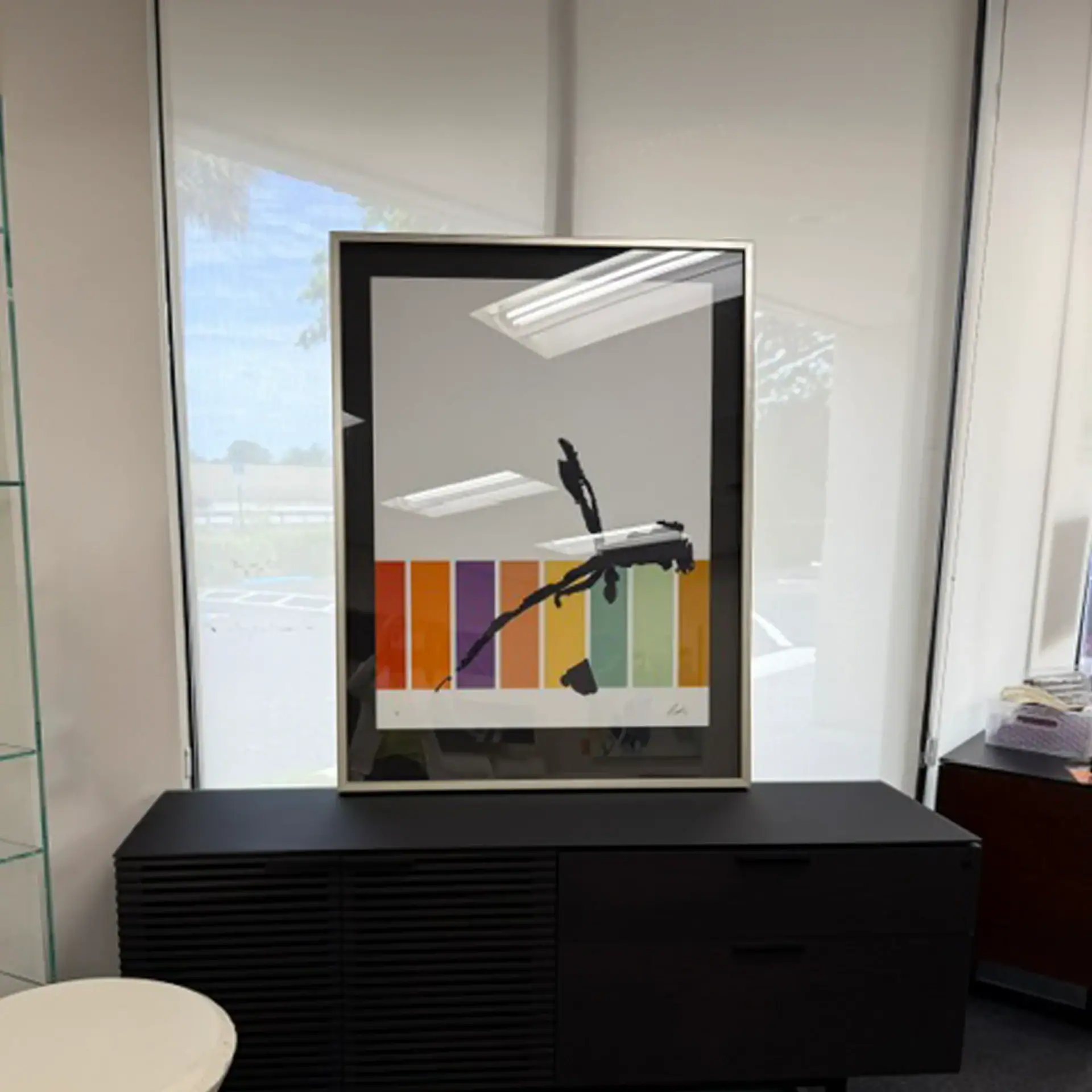 Modern bird wall art with vibrant colors on a white wall.