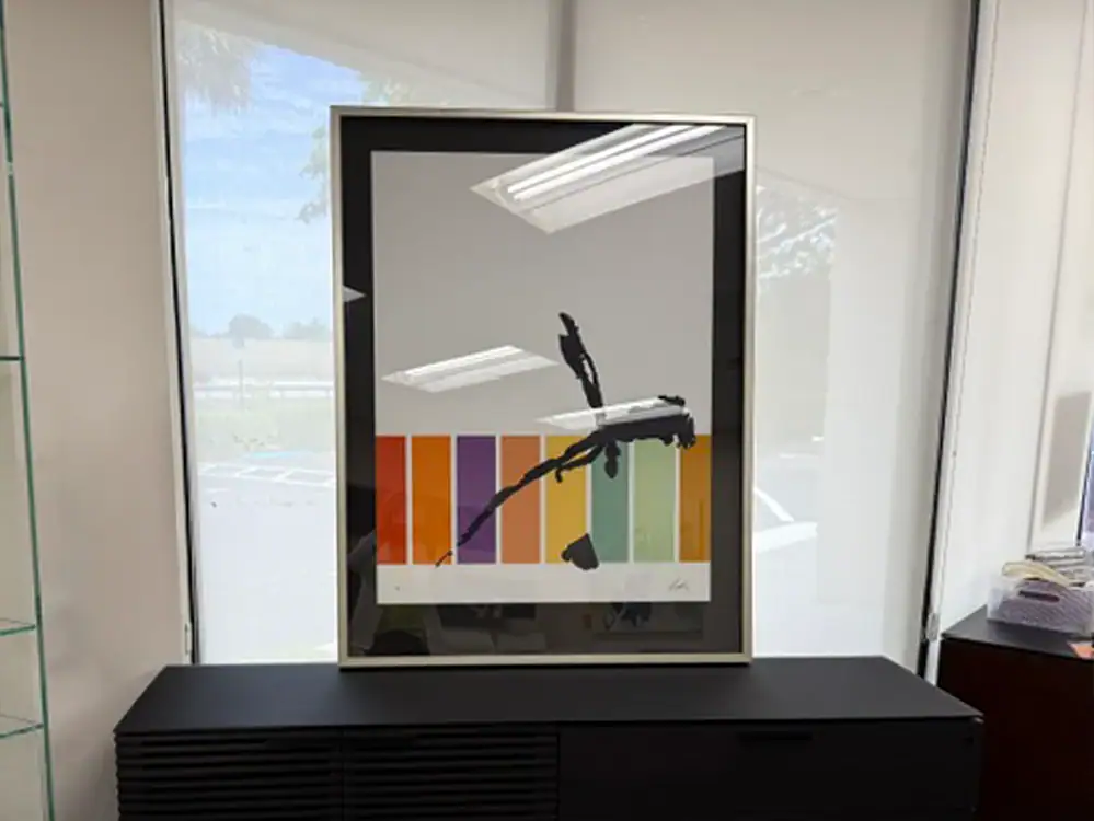 Modern wall art featuring a black goat silhouette on colorful striped background.