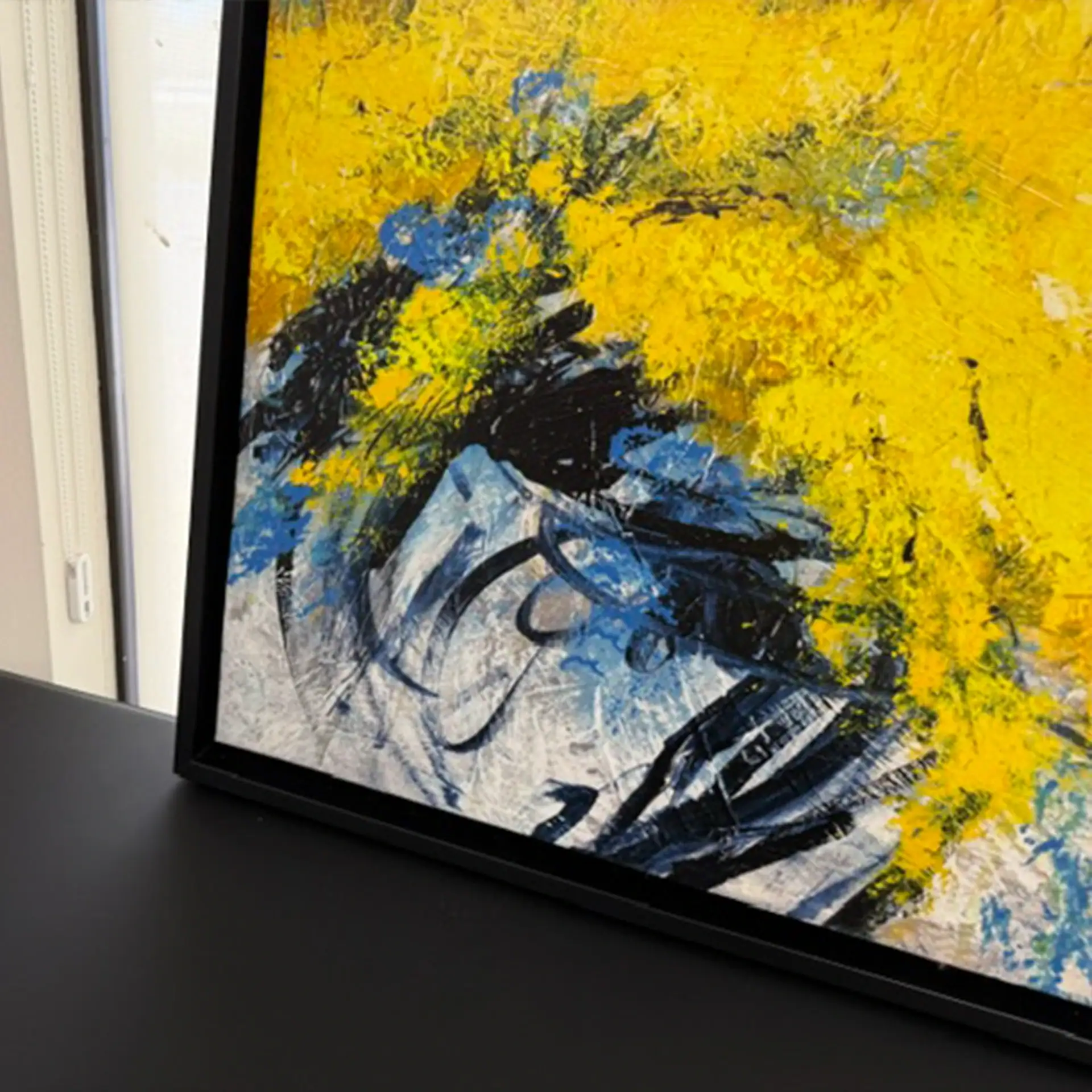 Abstract yellow, blue, and black wall art for modern interior decor.
