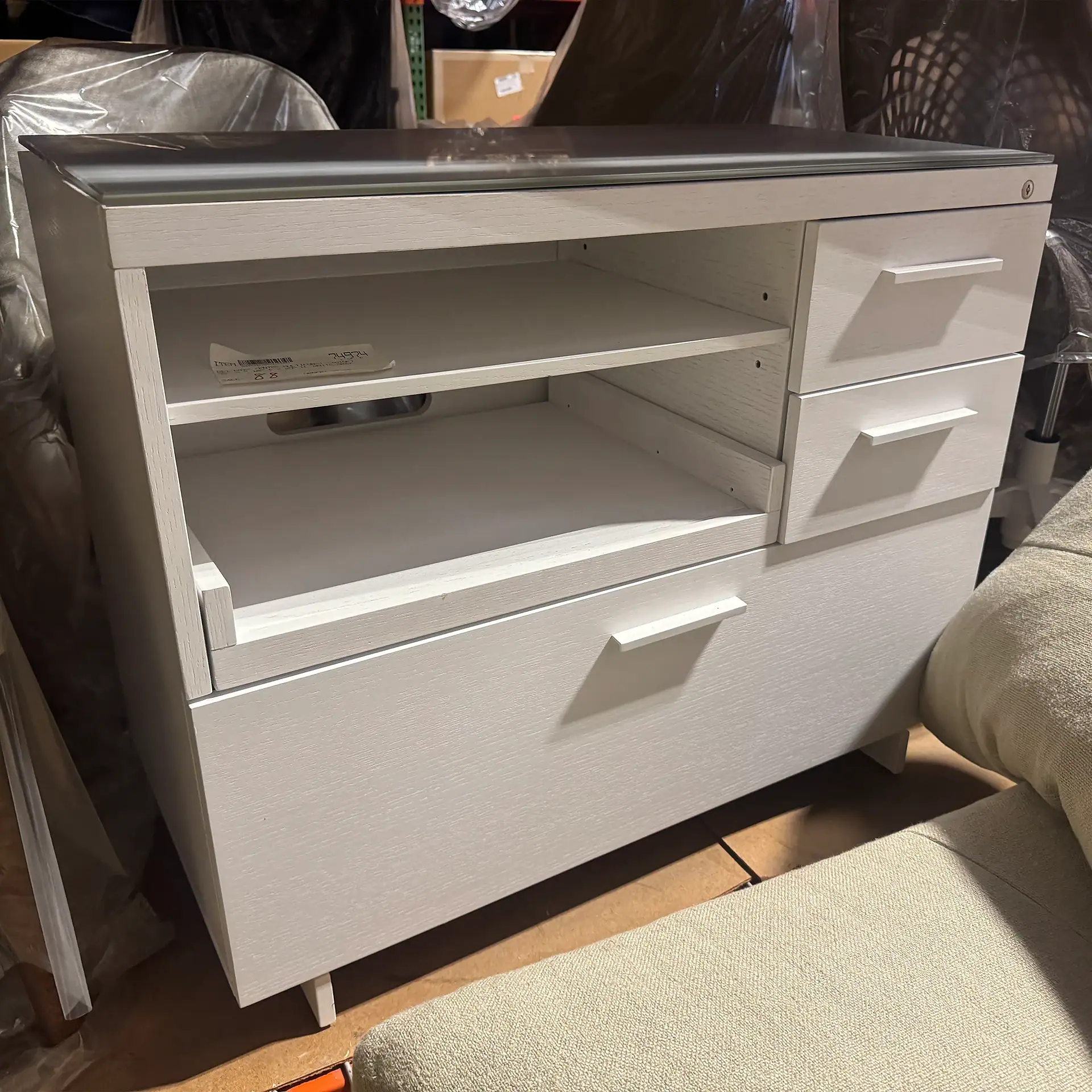 Modern white multifunction cabinet with open shelves and drawers for storage.
