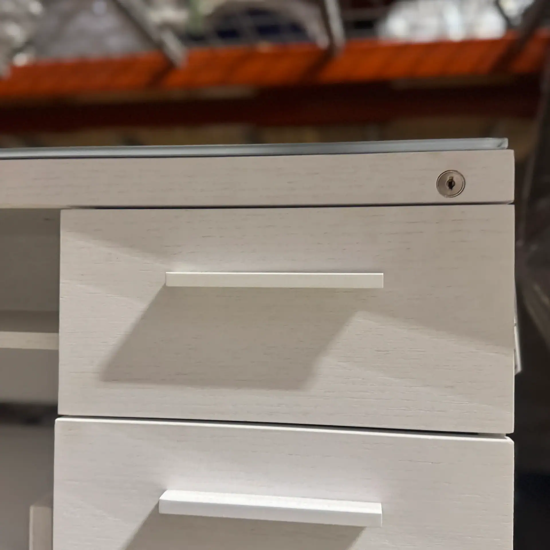Modern white multifunction cabinet with handle and lock for living room or office.