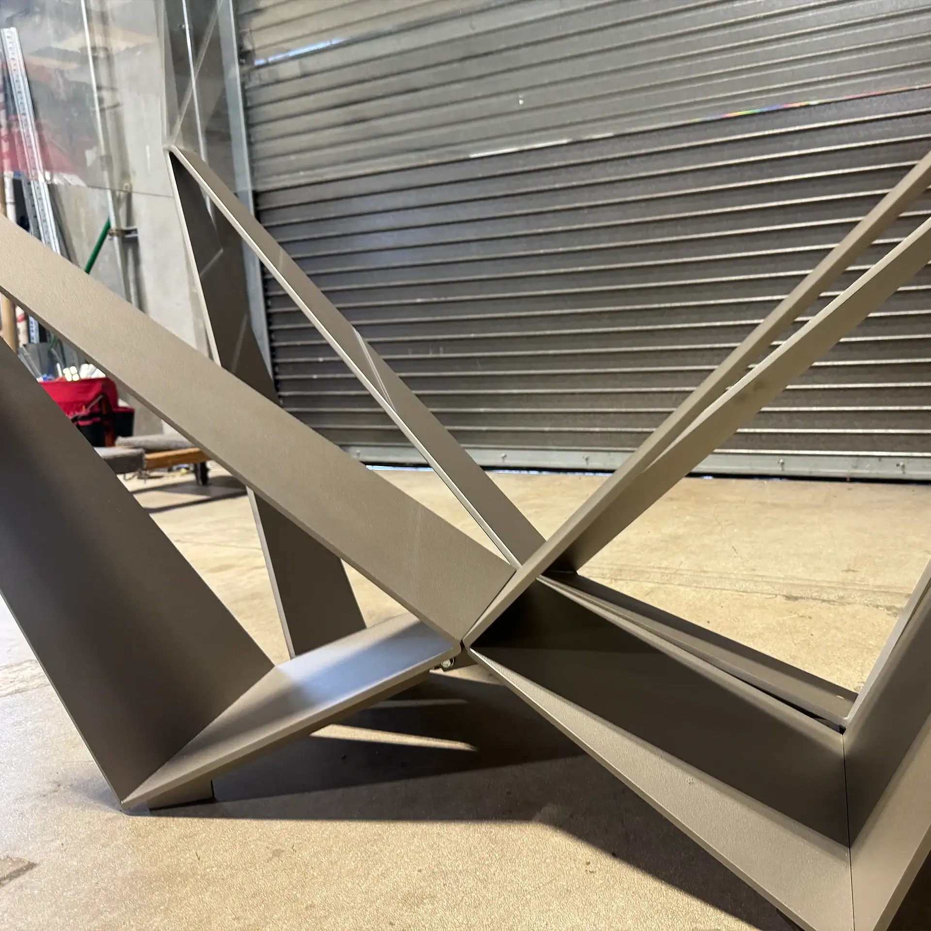 Contemporary metal table base with angular design for dining room.