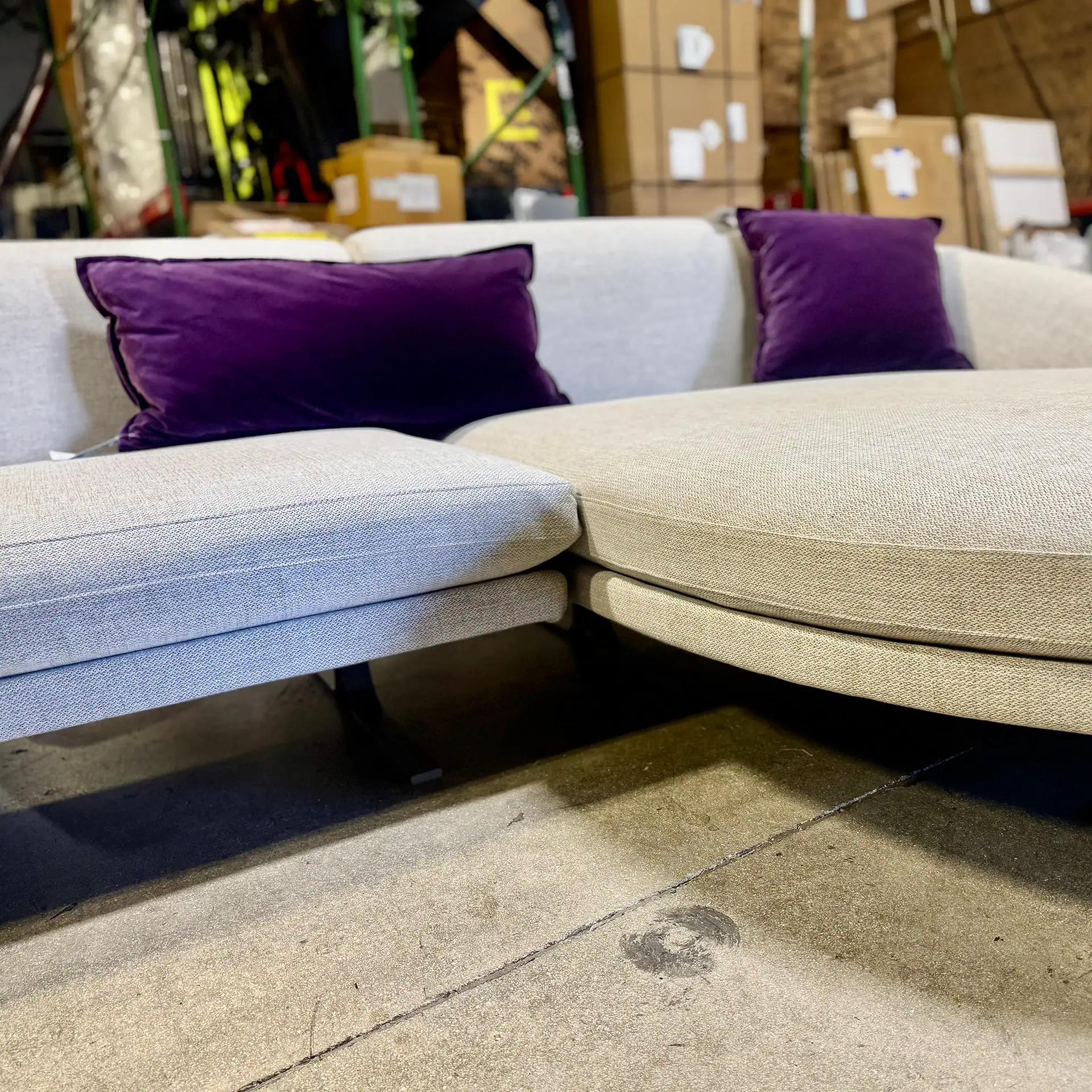 Modern Loft Airstrike Sofa with purple pillows at Sklar Furnishings.