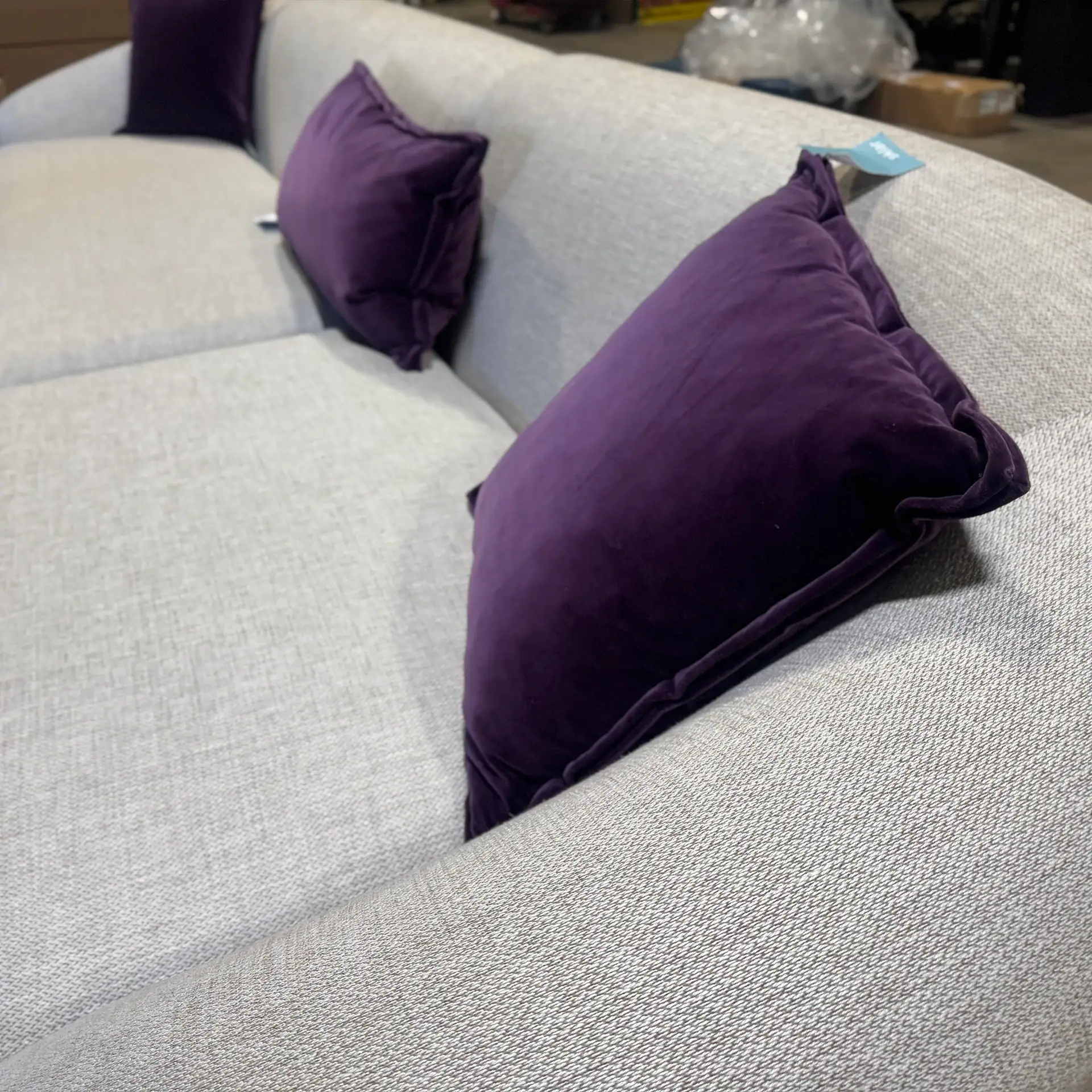 Modern sofa with purple cushions from Sklar Furnishings.