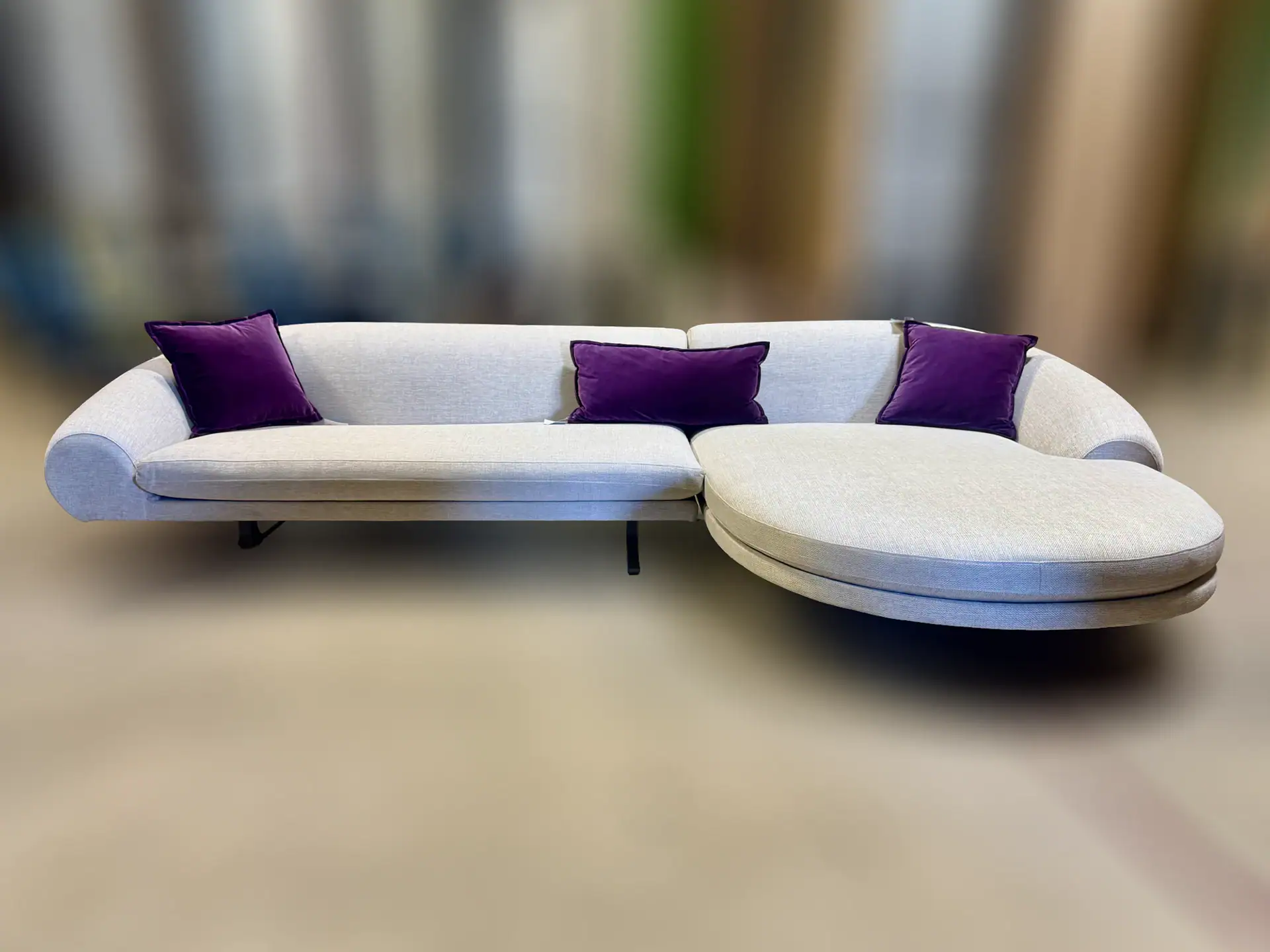Modern Loft Airstrike sofa with purple cushions in a stylish living room.