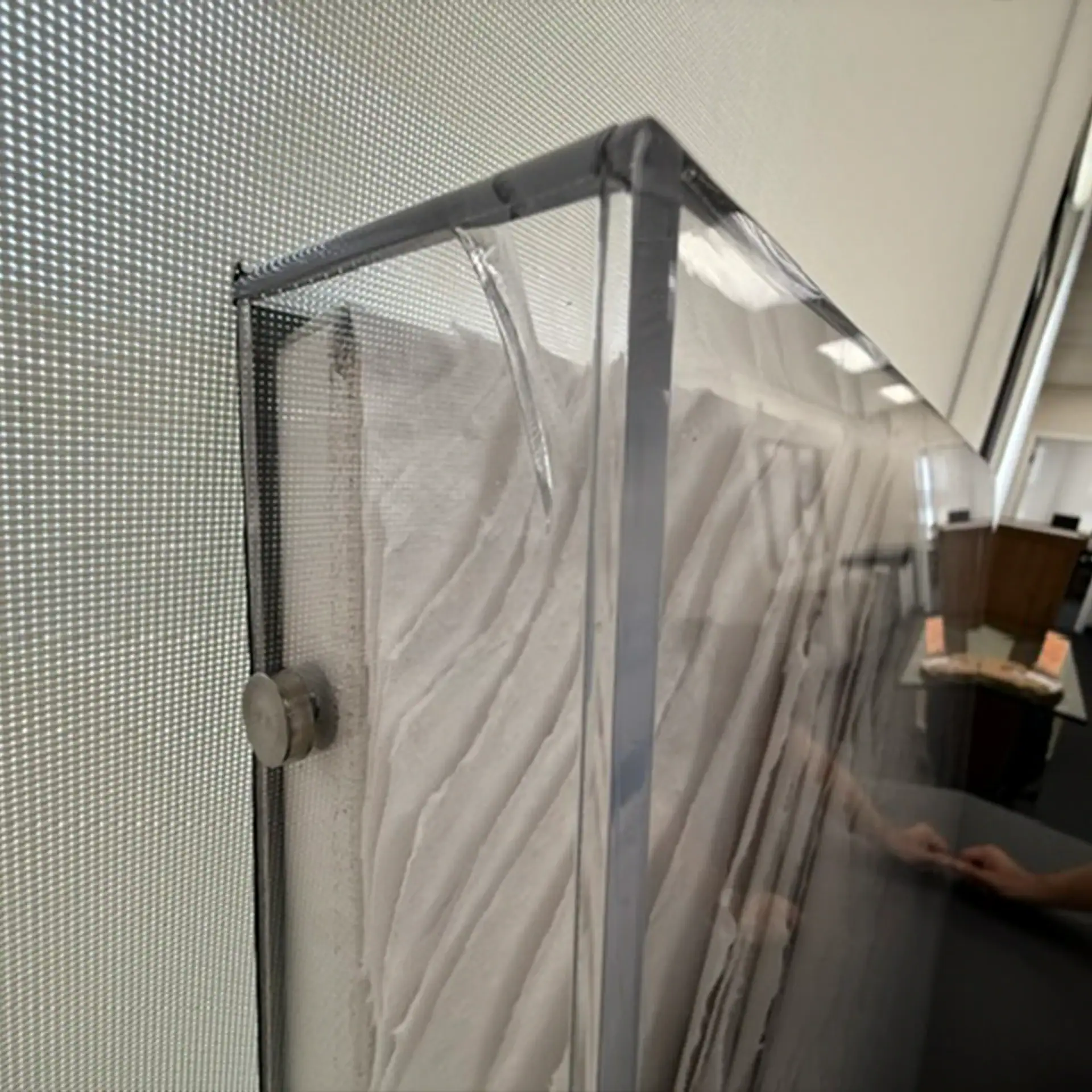 Protective plastic cover on Sklar Furnishings wall art piece.