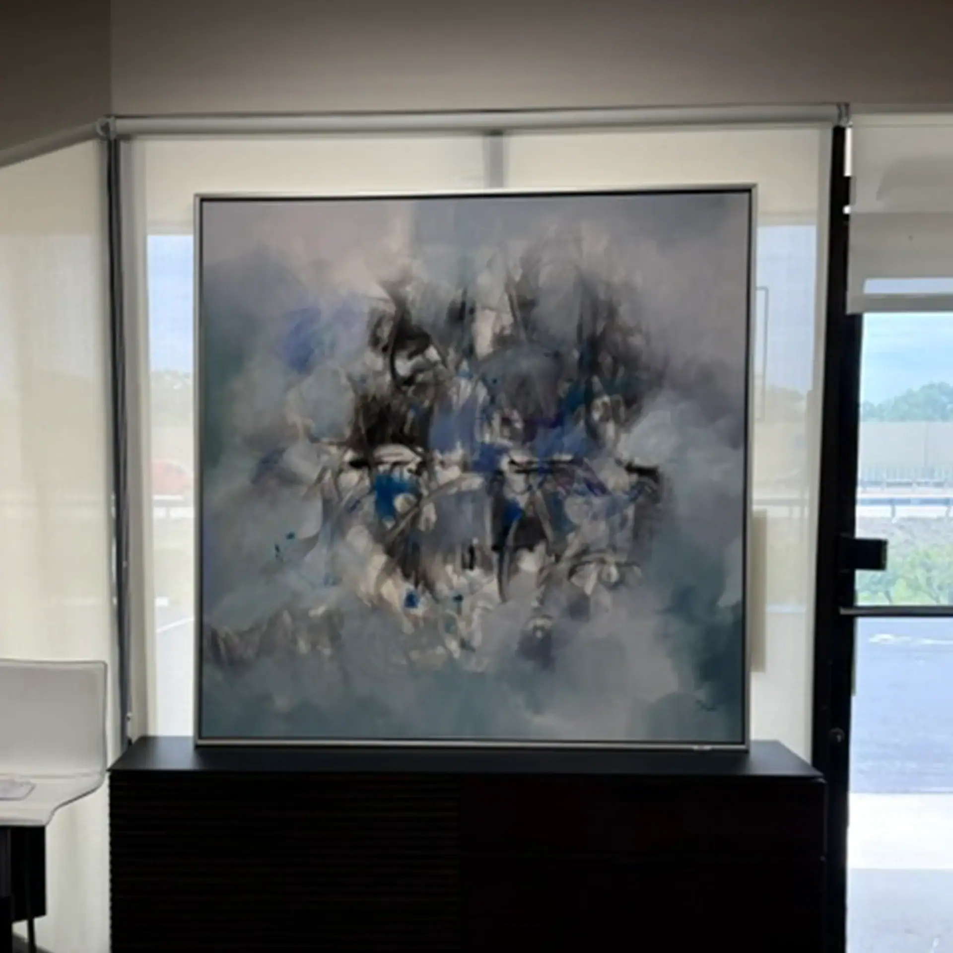 Abstract floral wall art with blue, black, and white tones for modern decor.