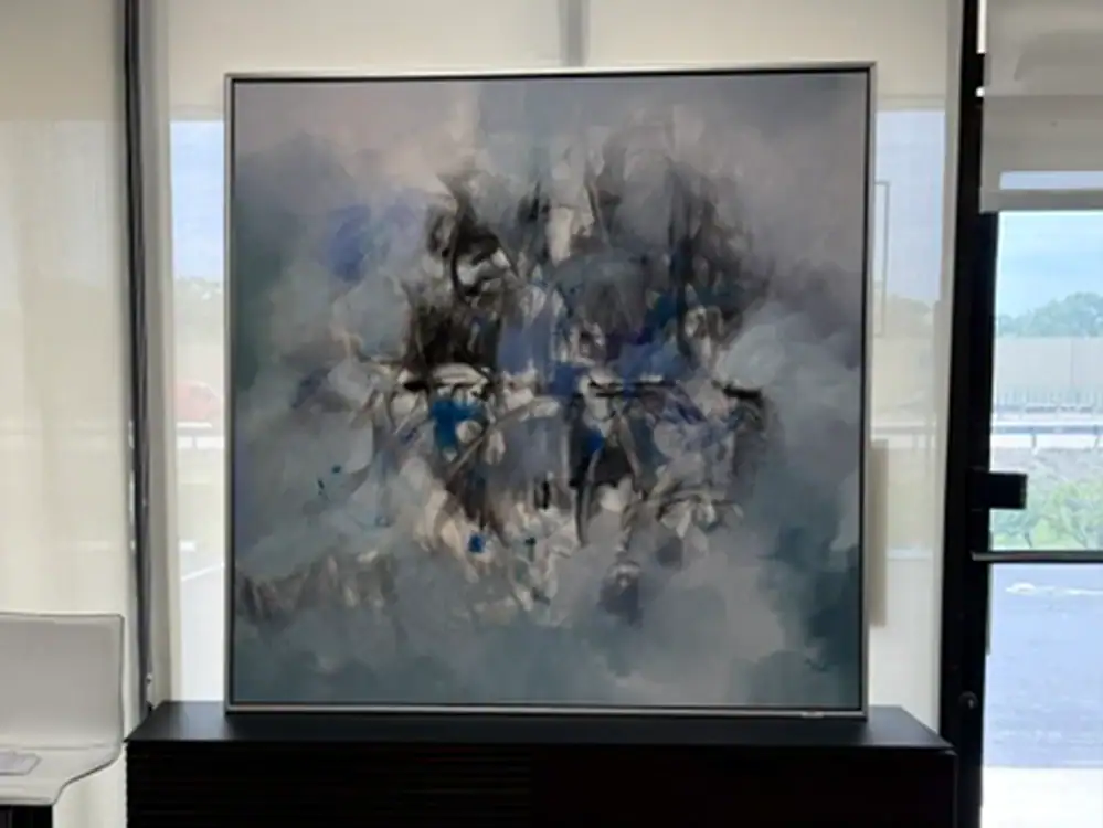 Abstract floral wall art with blue, black, and white tones for modern decor.