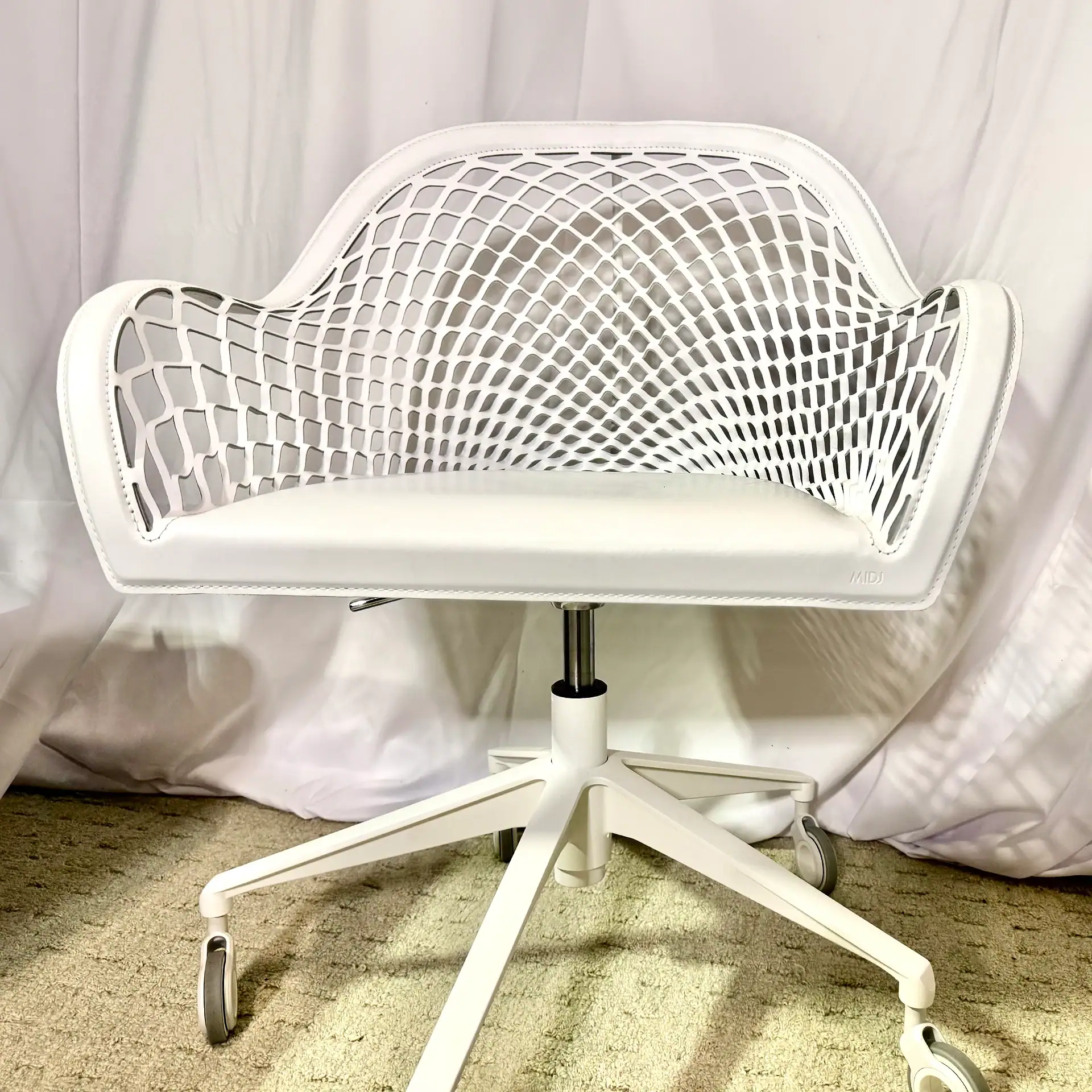 Modern white office chair with a lattice back design and adjustable height.