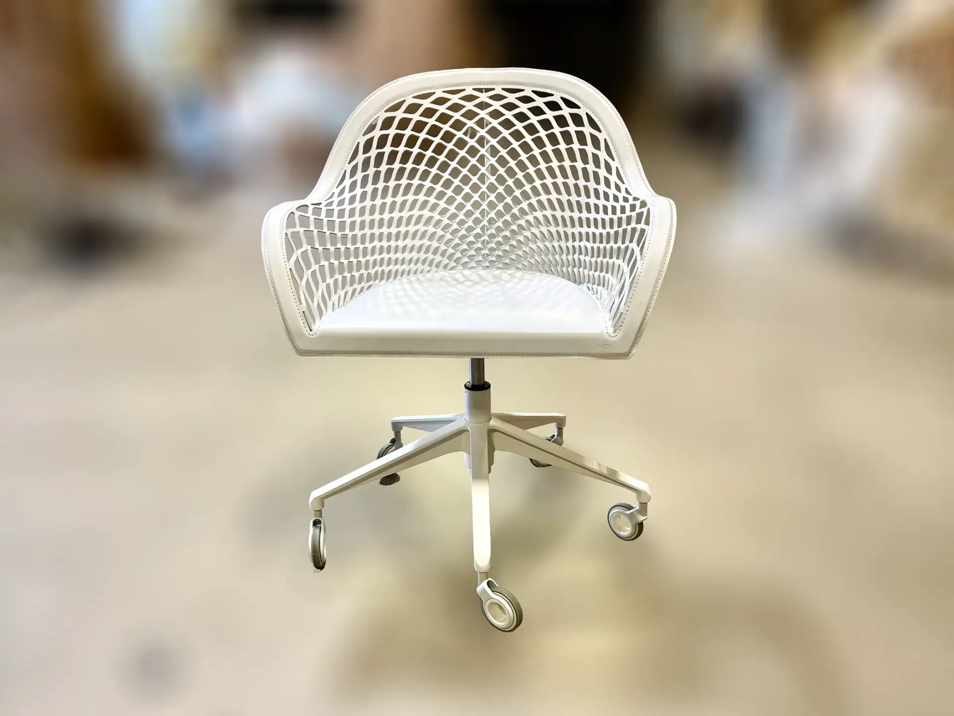 Modern white office armchair with mesh back and swivel base.