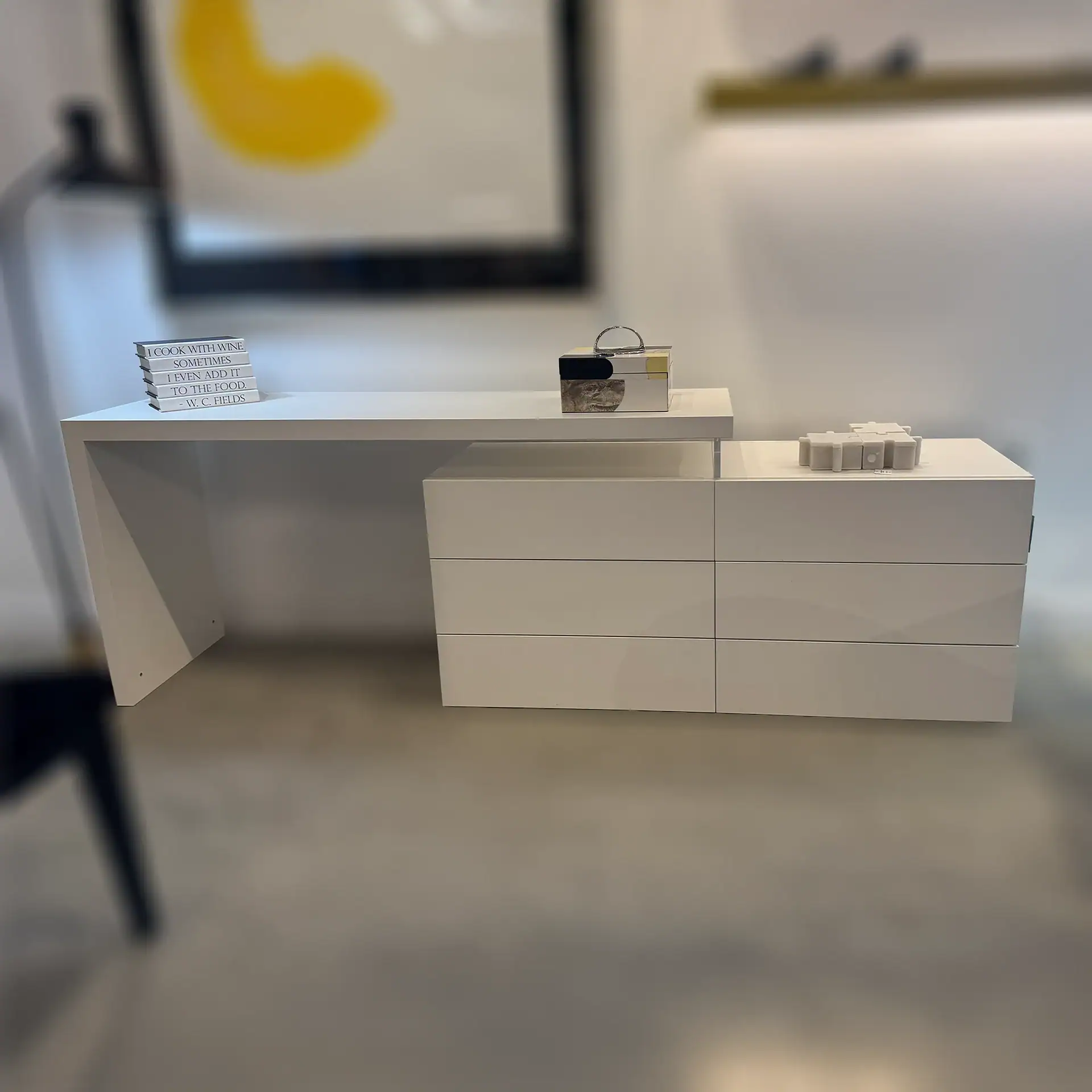 Contemporary white desk and dresser with clean lines and minimalist design.