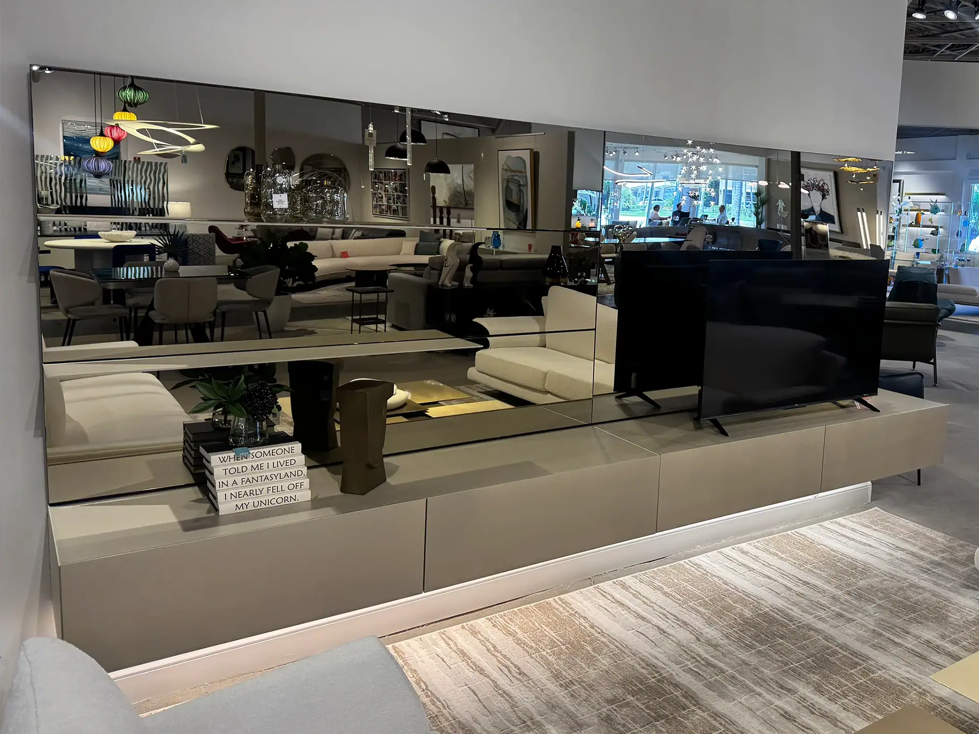 Modern Sklar Furnishings wall unit with TV and storage in showroom.
