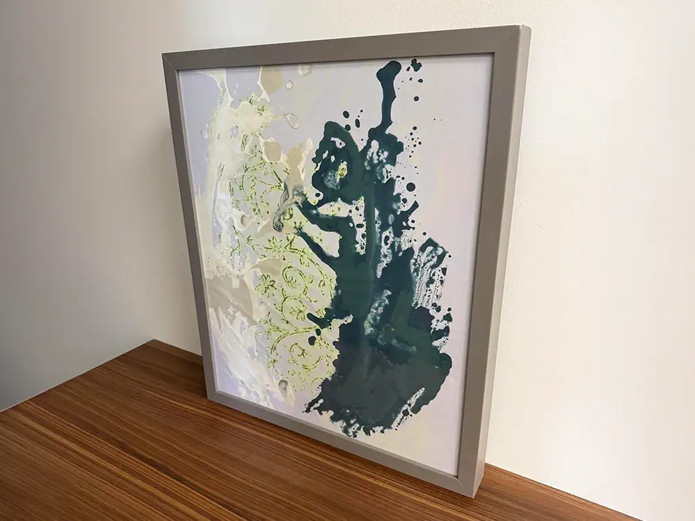 Abstract wall art with green, white, and navy splashes, perfect for contemporary interior design.
