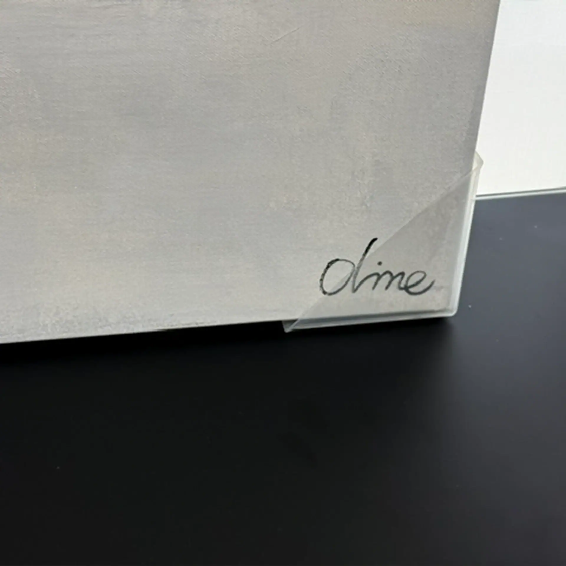 Close-up of wall art with the word 'dime' written on it.