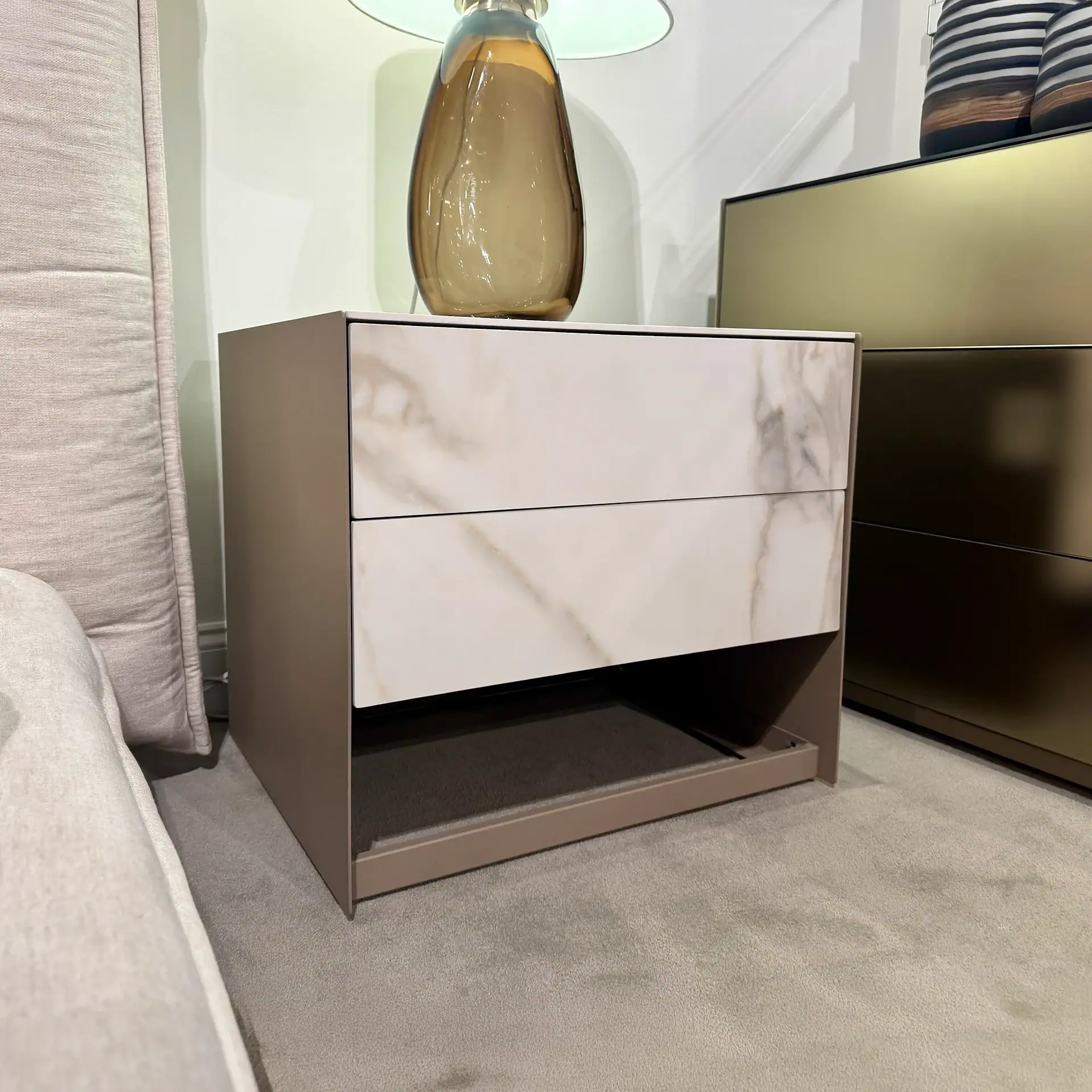 Modern nightstand with marble finish and open shelf for bedroom decor.