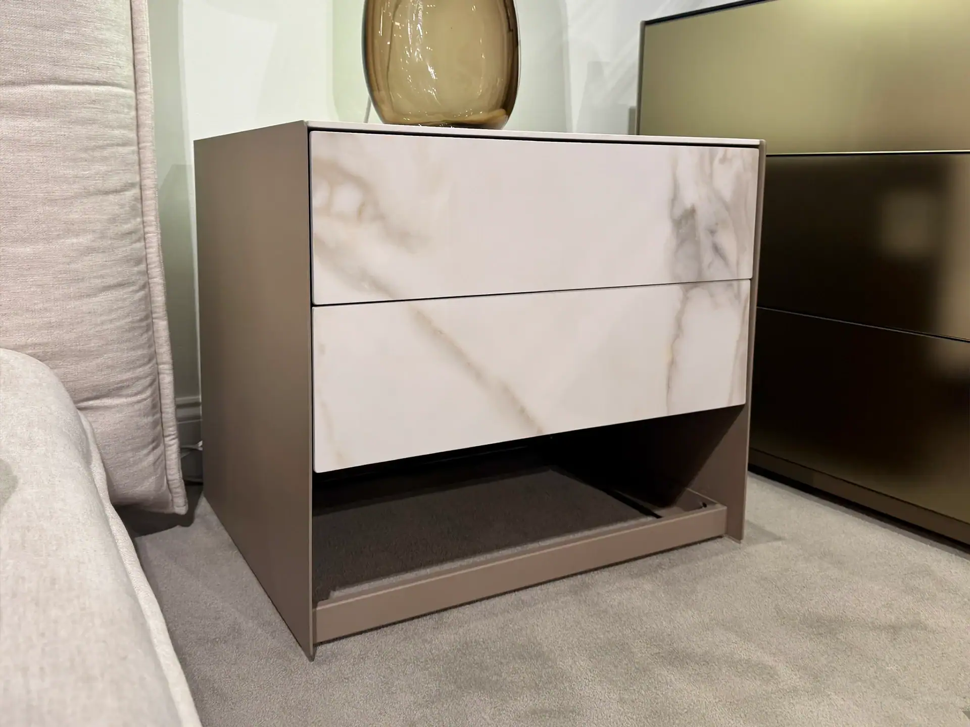 Modern nightstand with marble finish and open shelf for bedroom decor.