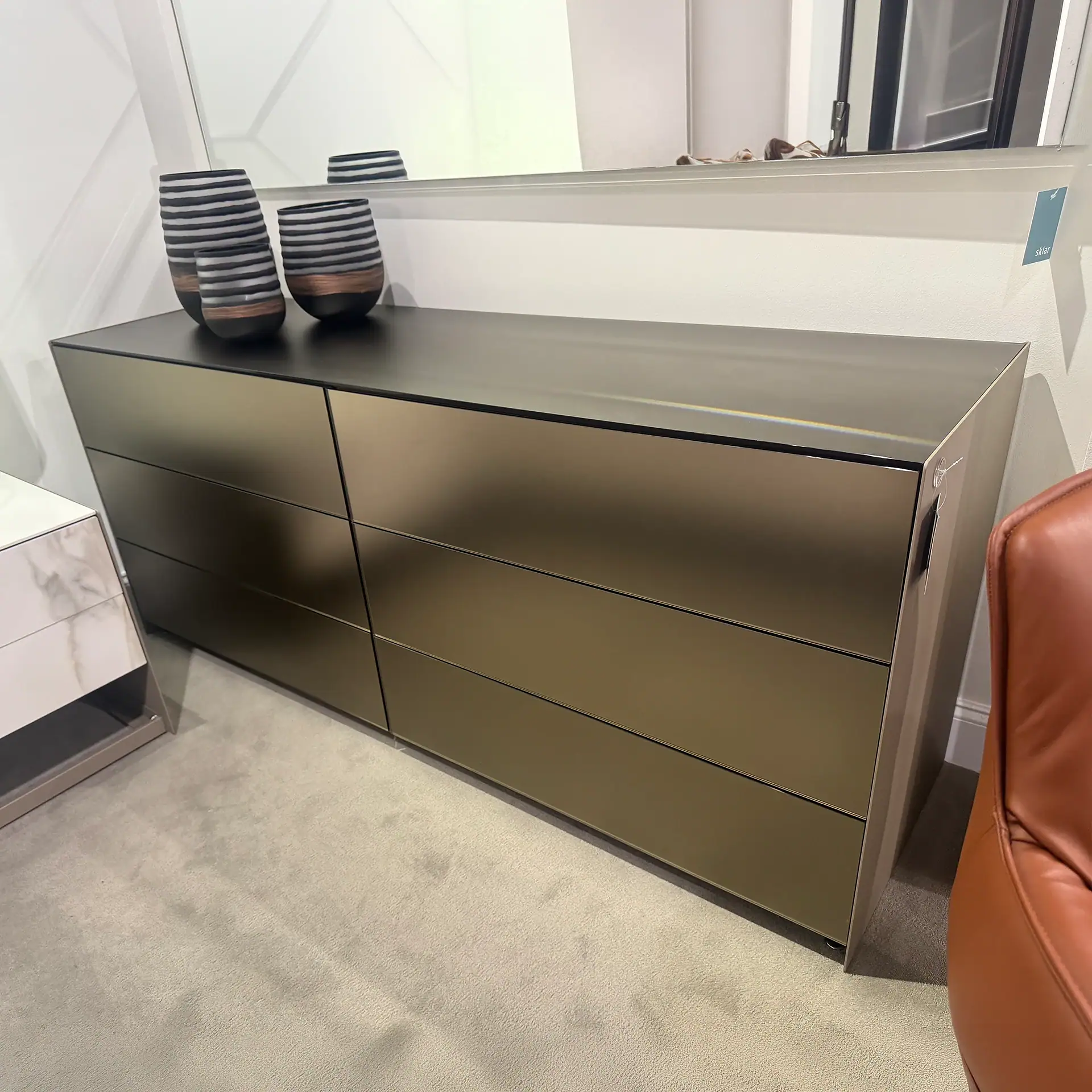 Modern six-drawer dresser with a sleek matte finish in a contemporary room.