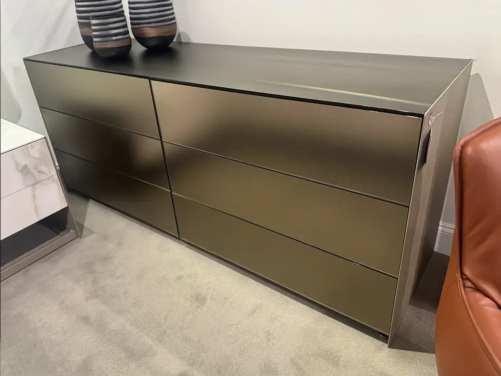 Modern metallic dresser with six drawers for stylish bedroom storage.